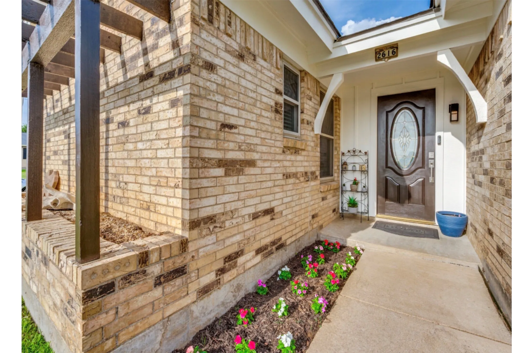 Brick exterior featuring an inviting covered entry