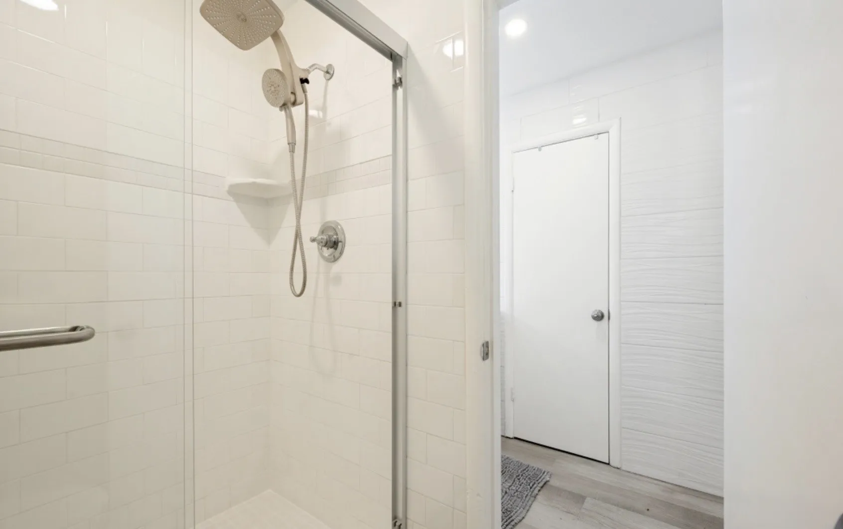 Contemporary shower enclosure featuring clear glass panels and chrome hardware