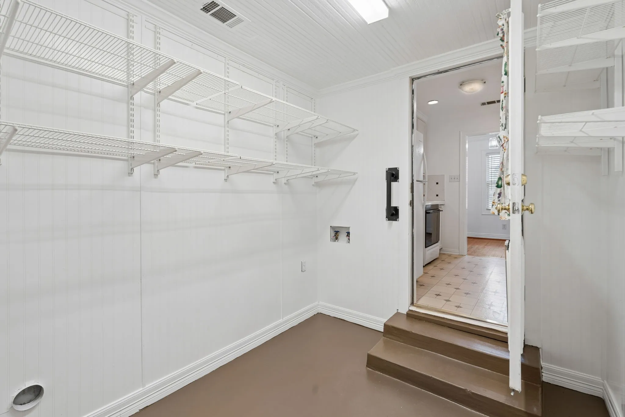 View of spacious utility room adjacent to the kitchen area.