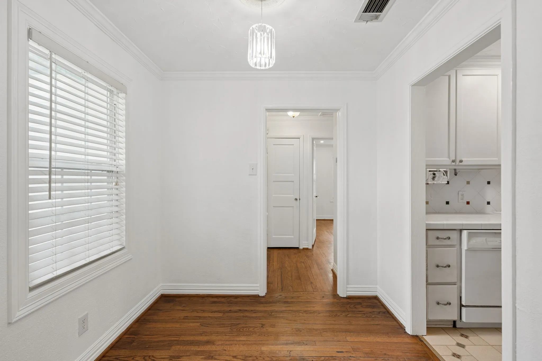View of dining area and hallway to the bedroom area.