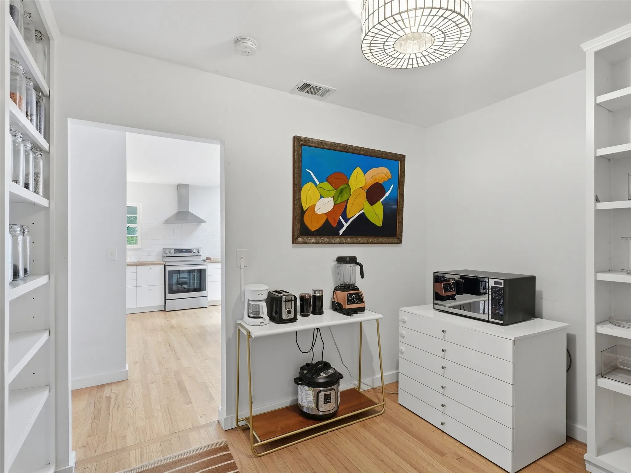 Hardwood-style flooring throughout this space with built-in shelving, providing extensive storage