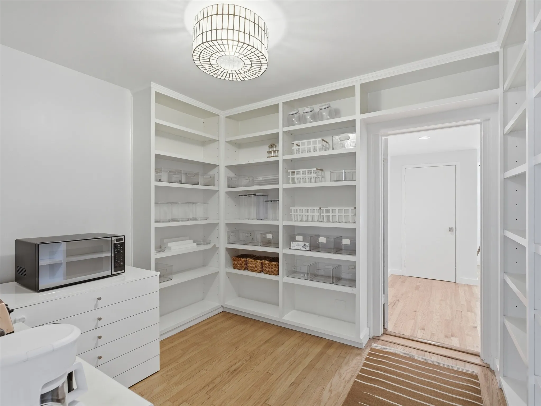 Built-in shelving with extensive storage, wood-finish flooring, and recessed lighting