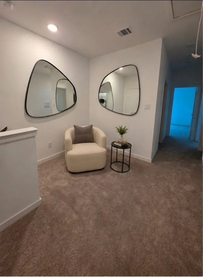 Carpeted landing area featuring recessed lighting and white walls