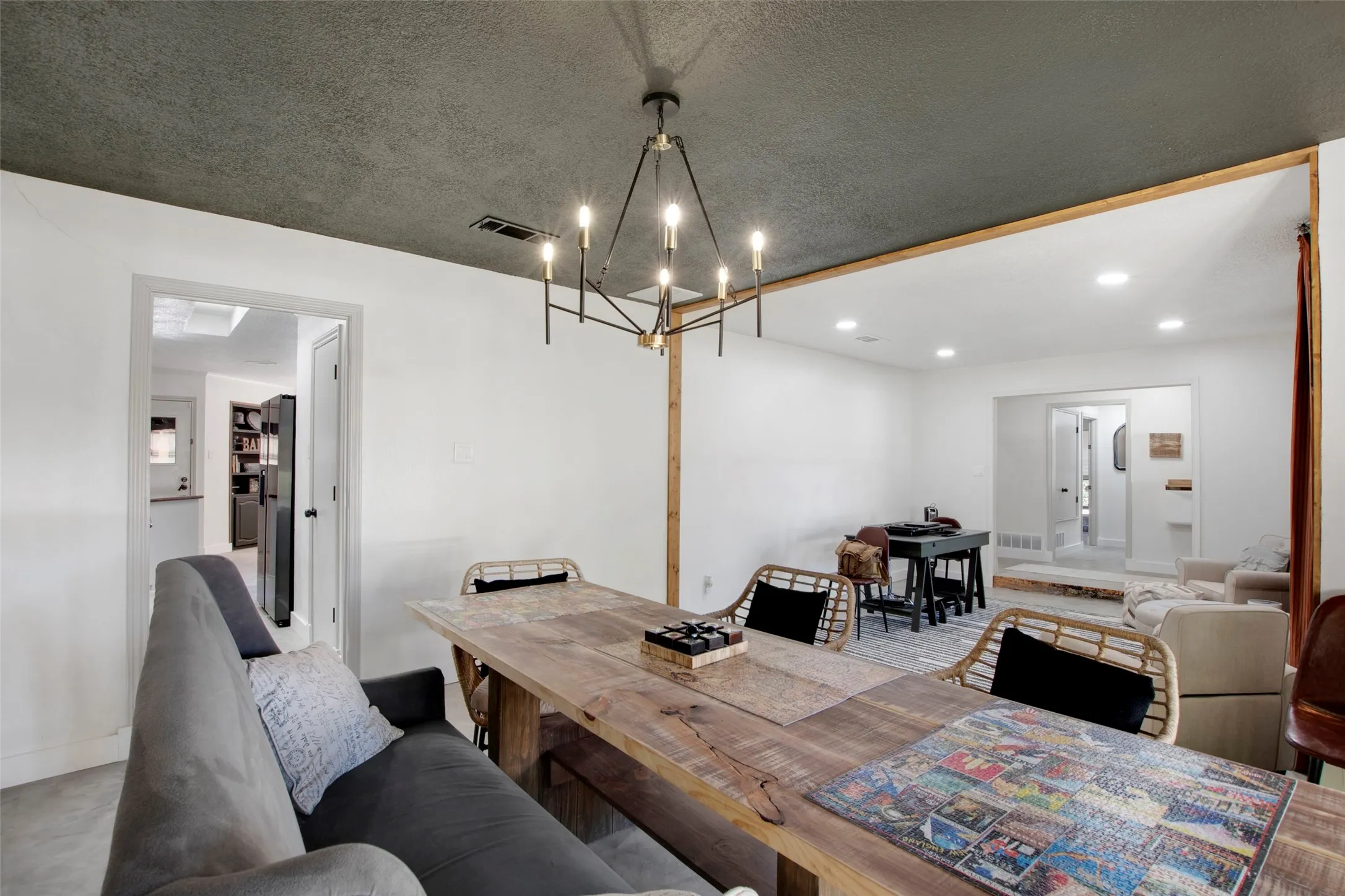 Dining space featuring a textured ceiling and an inviting chandelier