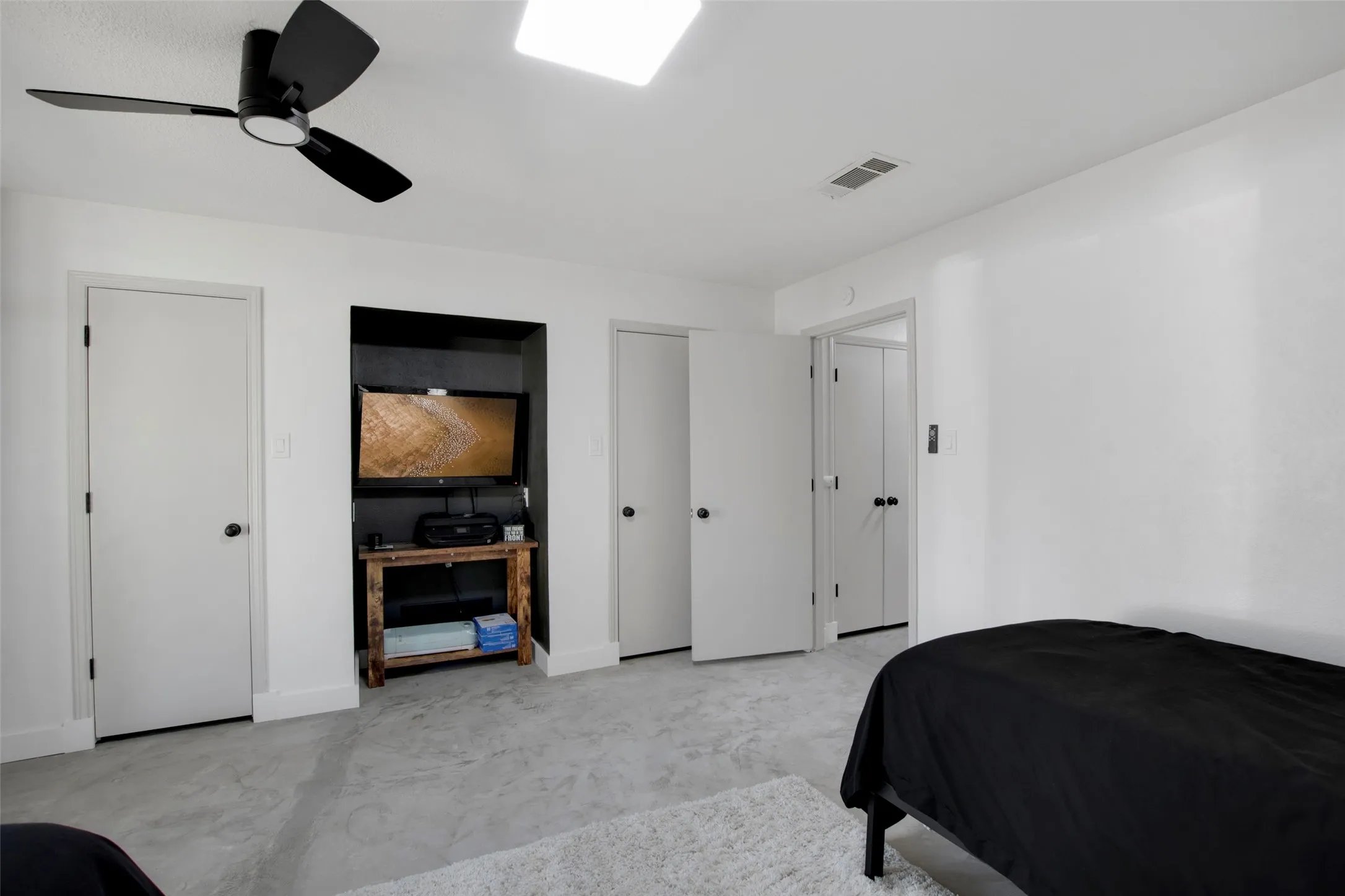 Bedroom with multiple closets and ceiling fan