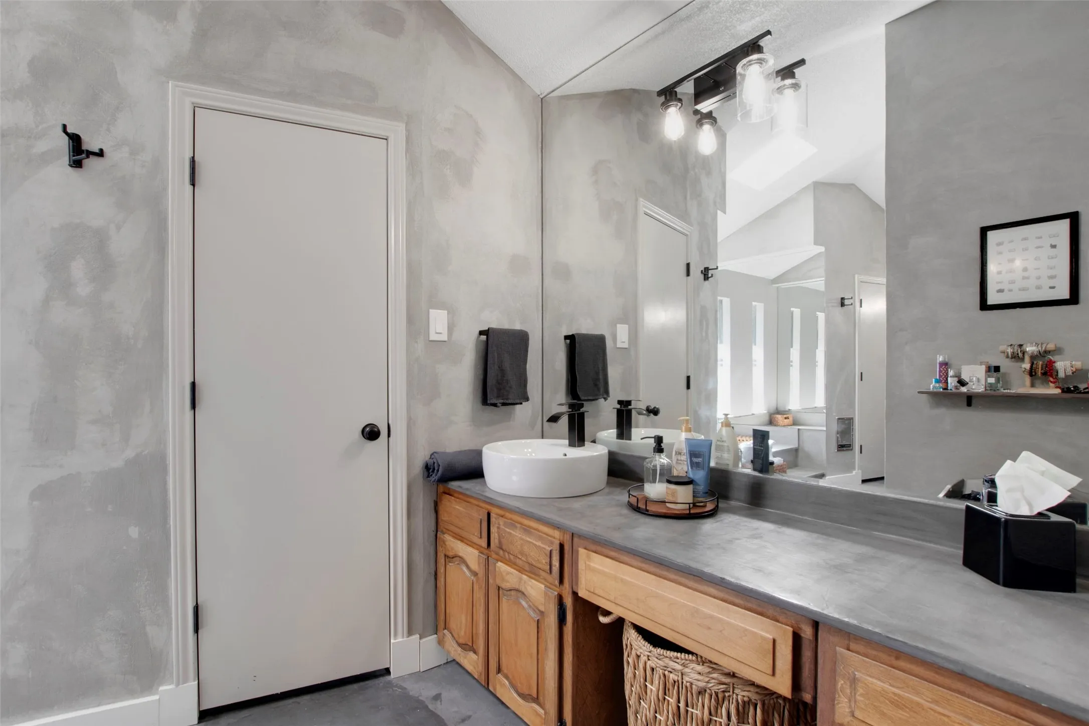 Bathroom with vanity and lofted ceiling