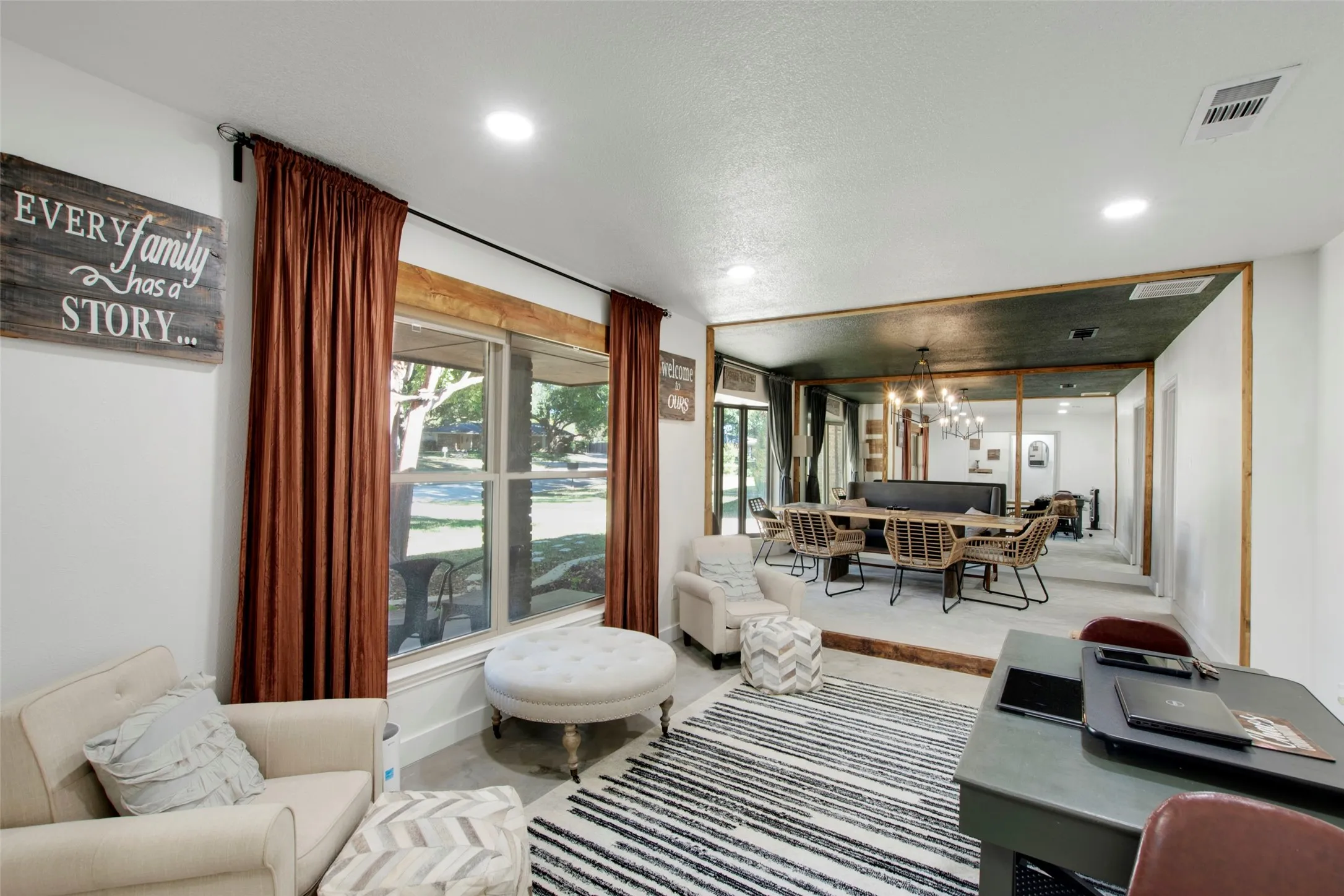 Living room featuring a chandelier and a textured ceiling