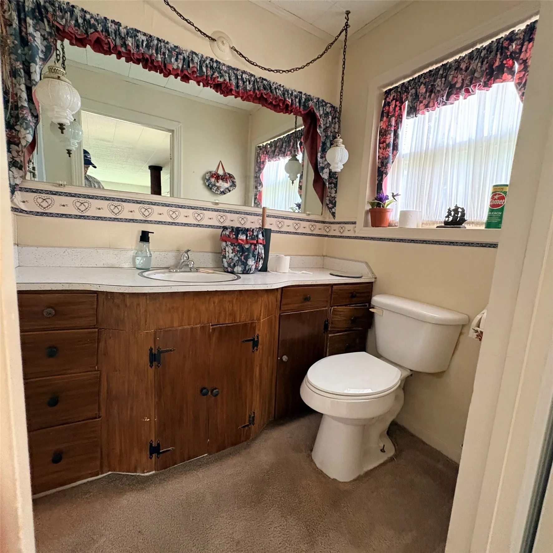 Bathroom vanity featuring a built-in sink, wooden cabinetry with multiple drawers, and a spacious​​‌​​​​‌​​‌‌​‌‌​​​‌‌​‌​‌​‌​​​‌​​ countertop