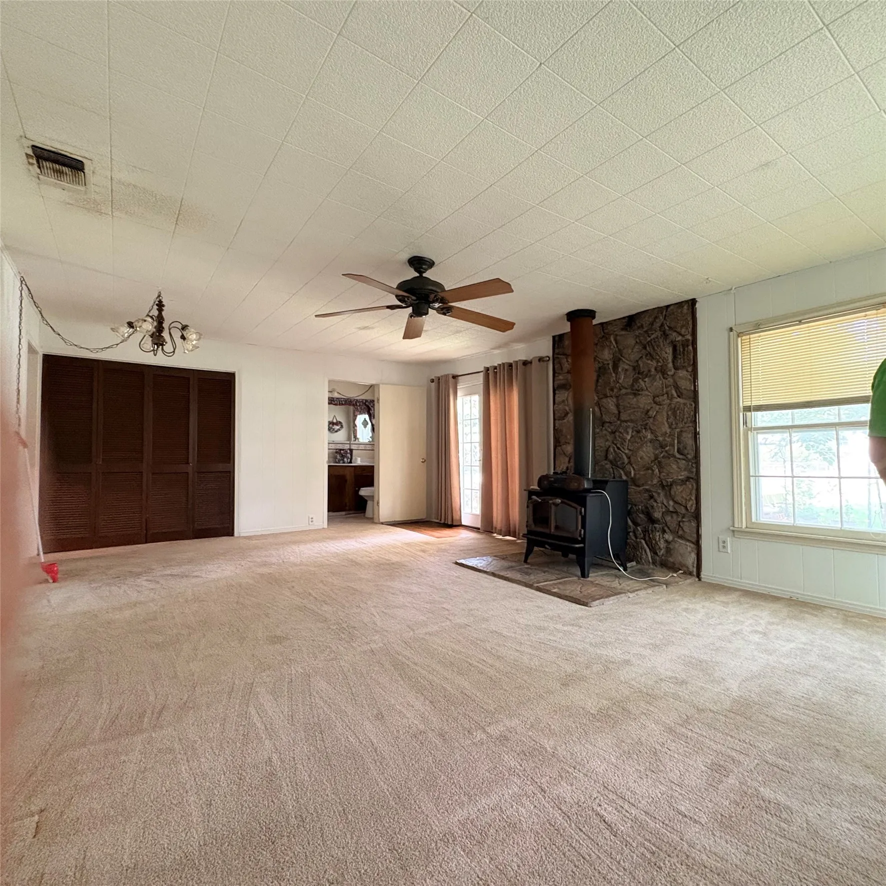Living area featuring carpet flooring and a stone accent wall