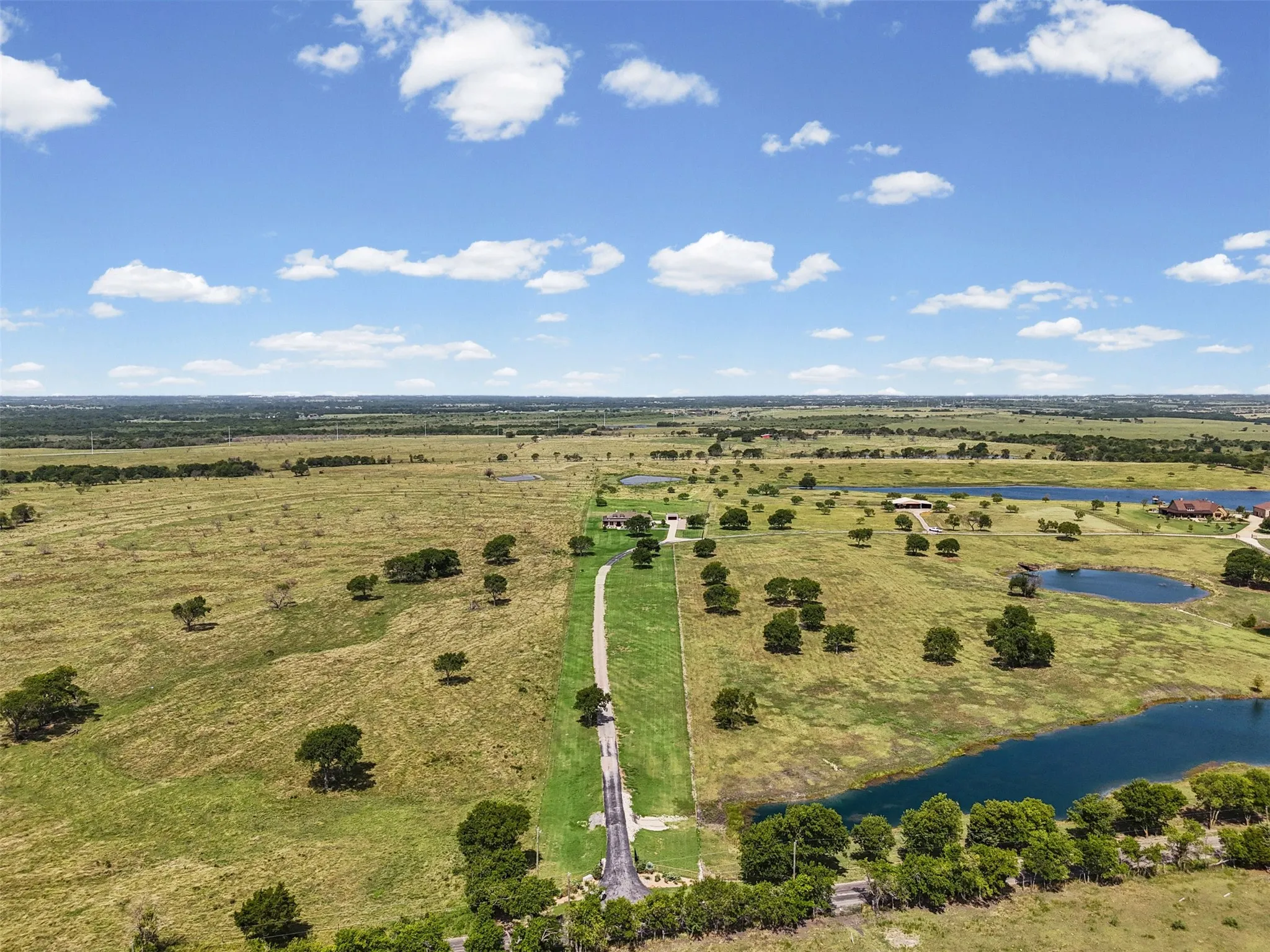 Full aerial view of the property from the front gate.  The property stretches back to the line of trees past the Tank.