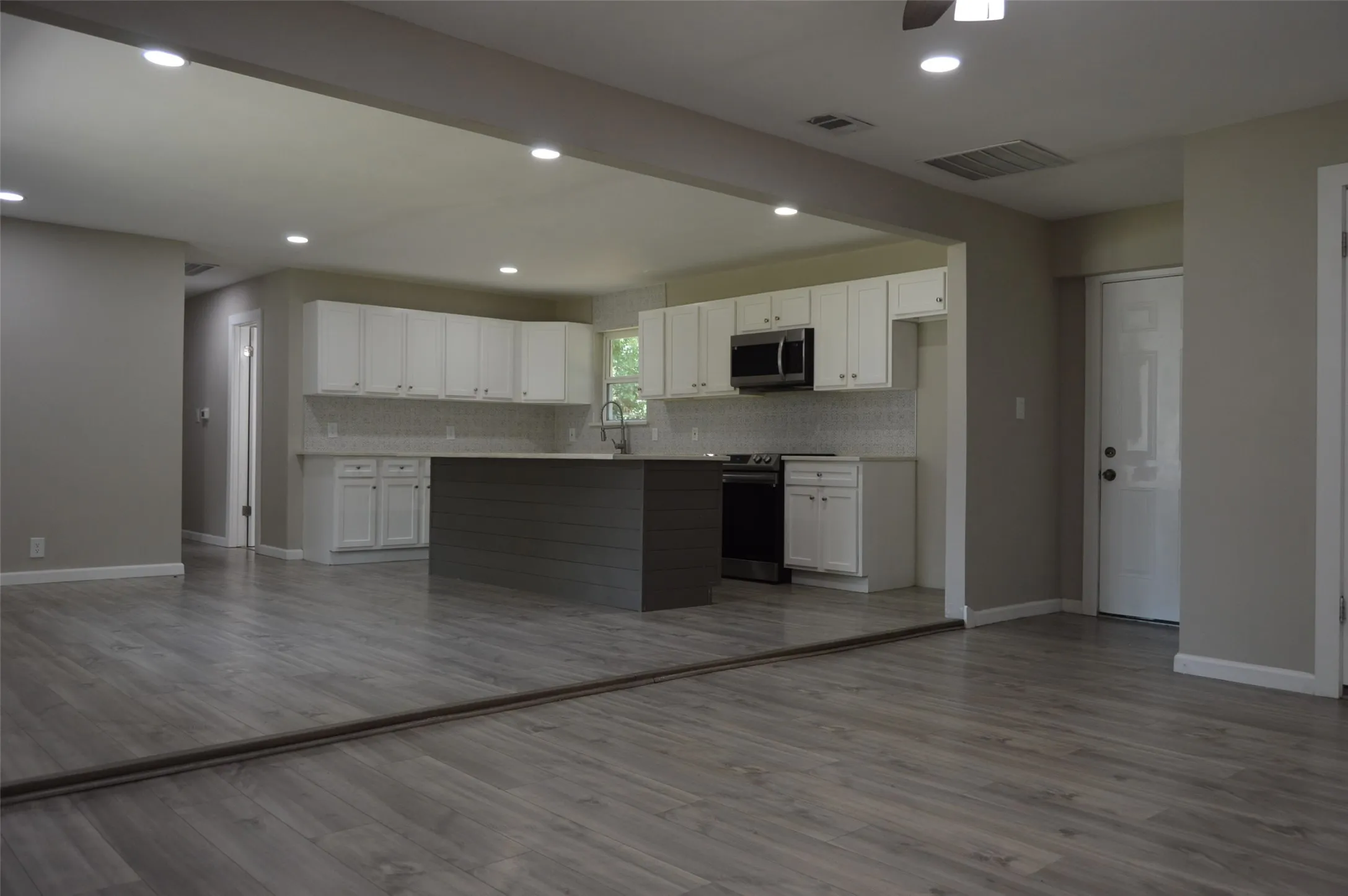 Looking at open concept to kitchen and dining