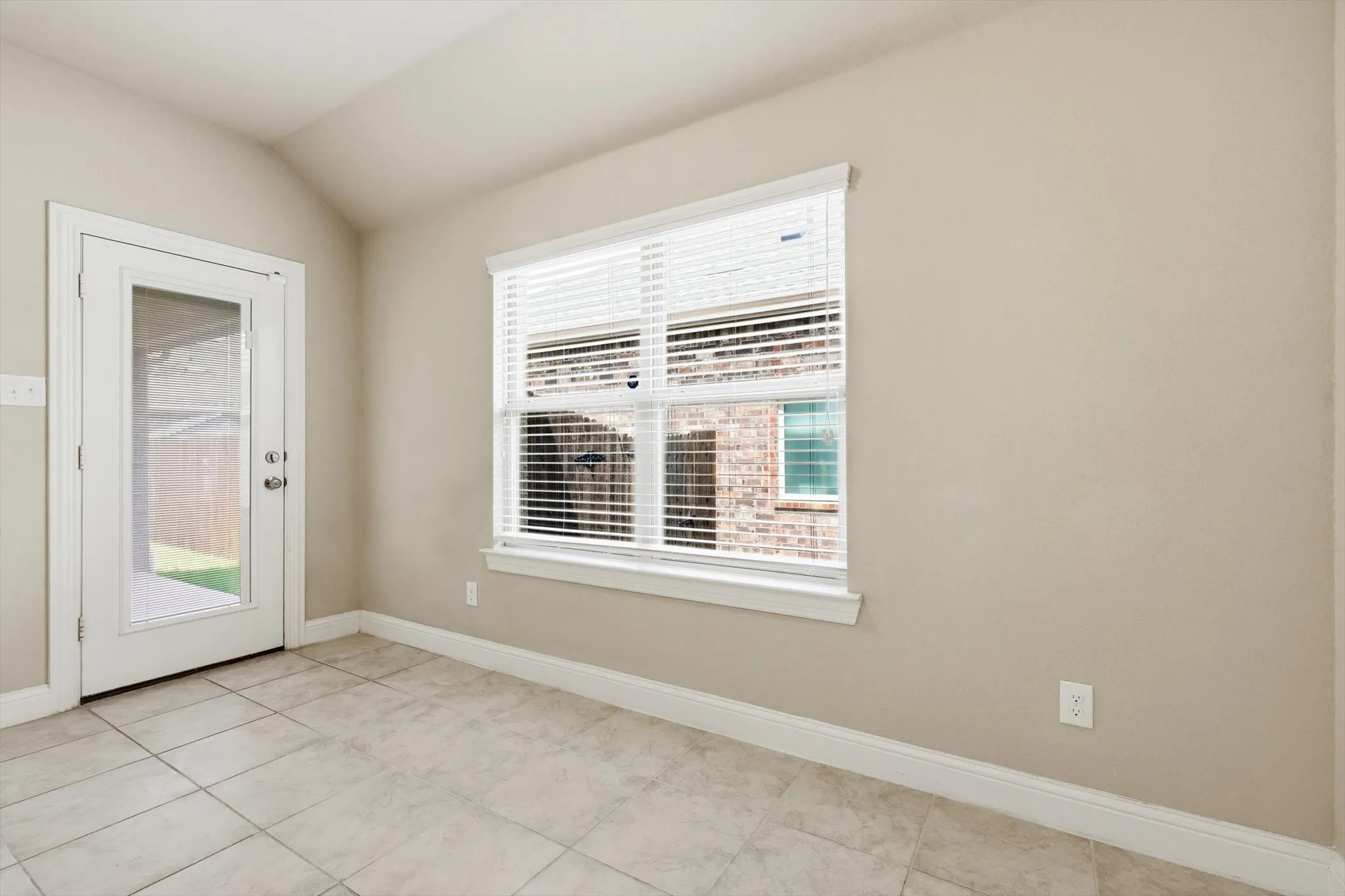 Room featuring tile flooring, neutral wall paint, and a white trim package