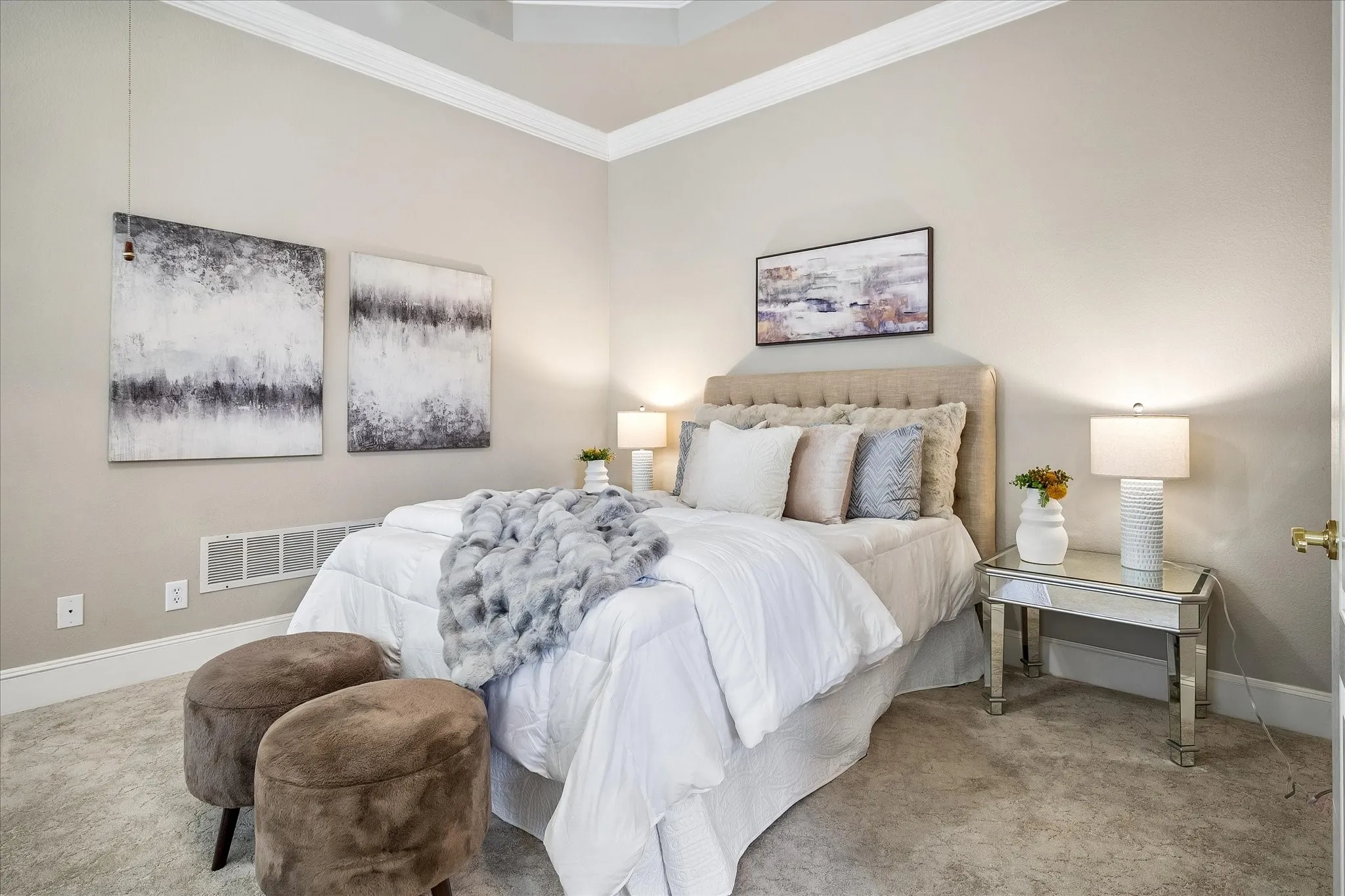Large Primary bedroom with tray ceiling, sitting area and Plantation Shutters.