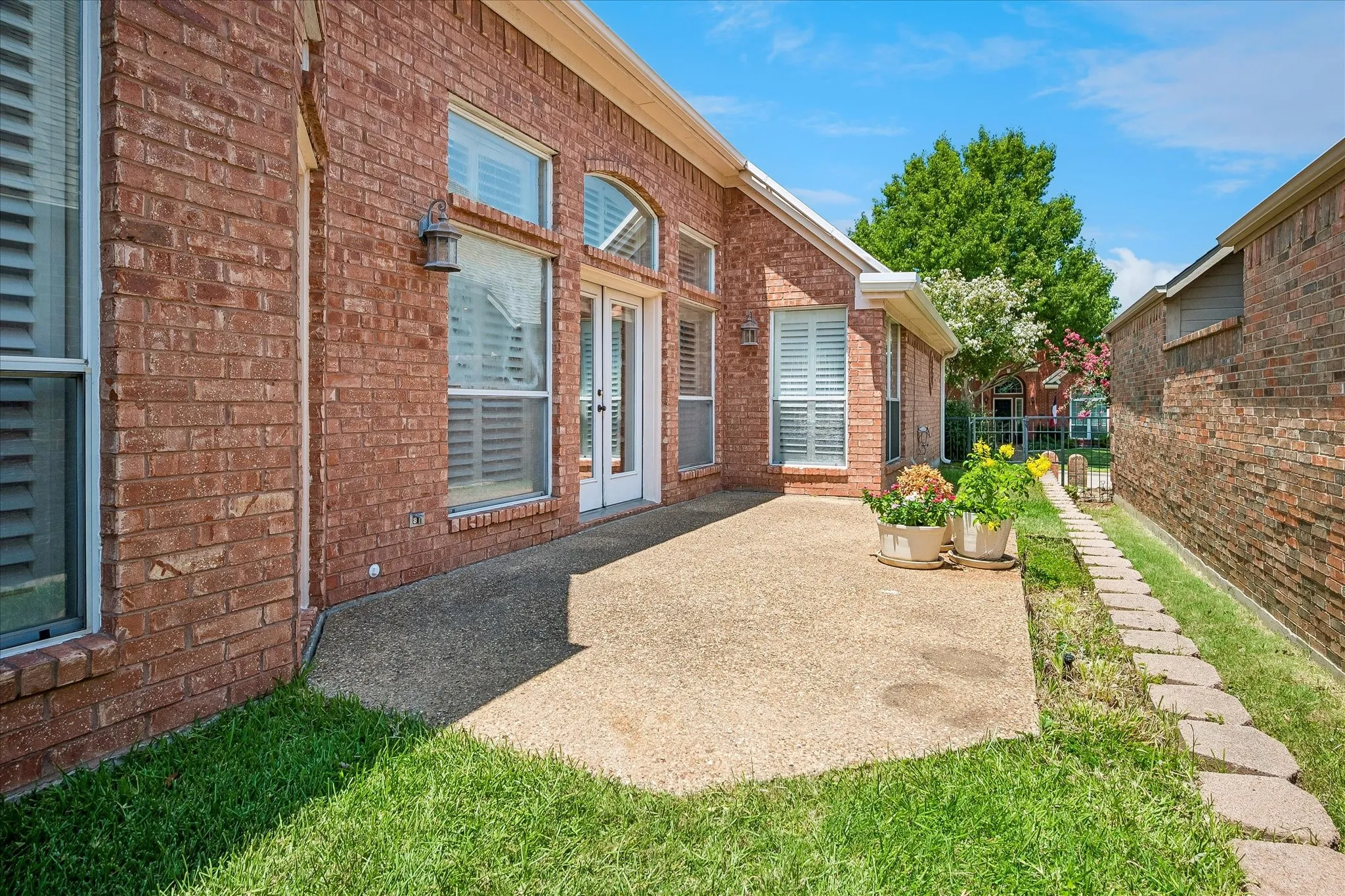 Patio and grassy area along side of home.
