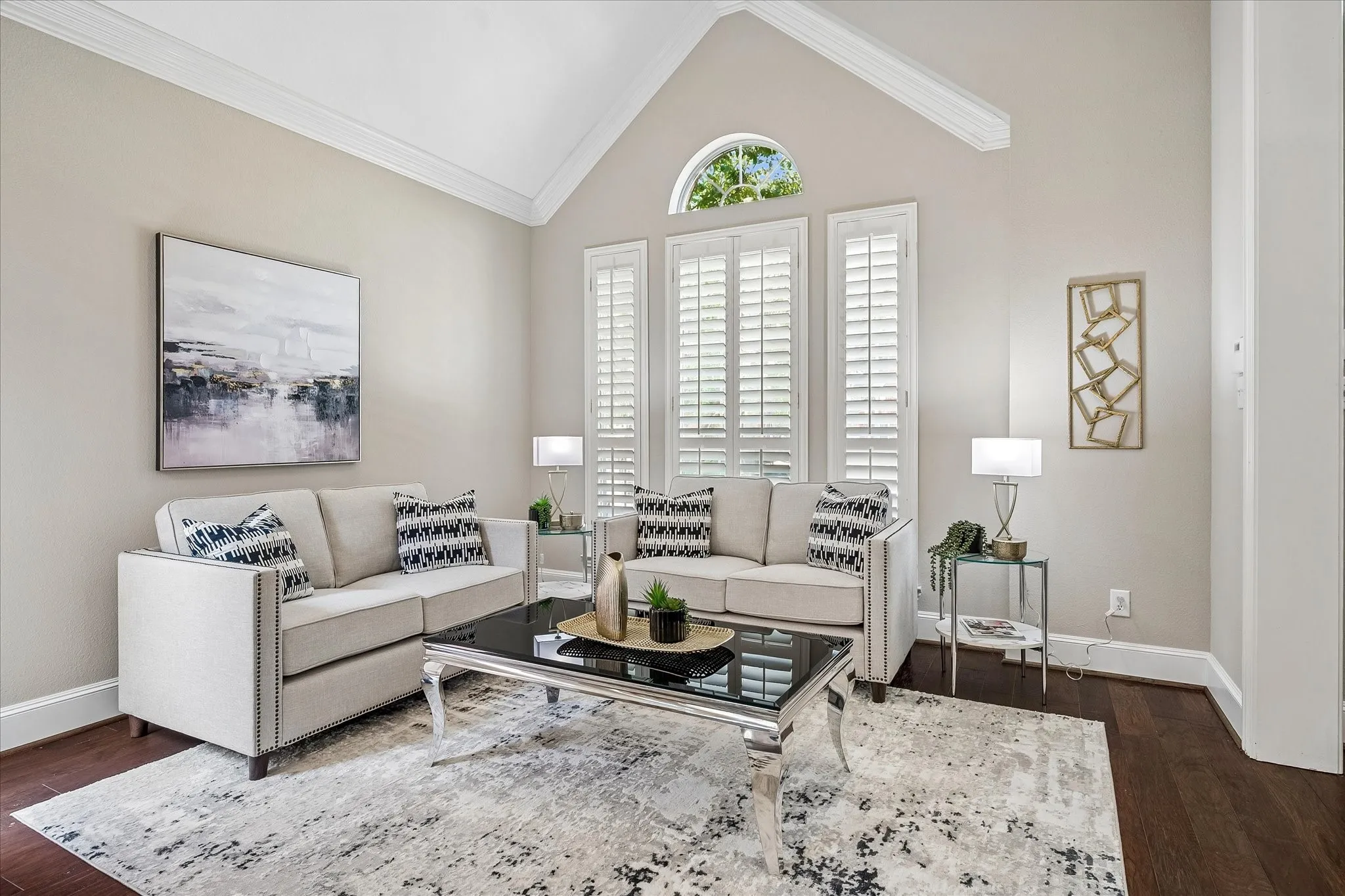 Living room with crown molding, shutters, wood flooring.  Or transform into a study, game room, etc.!