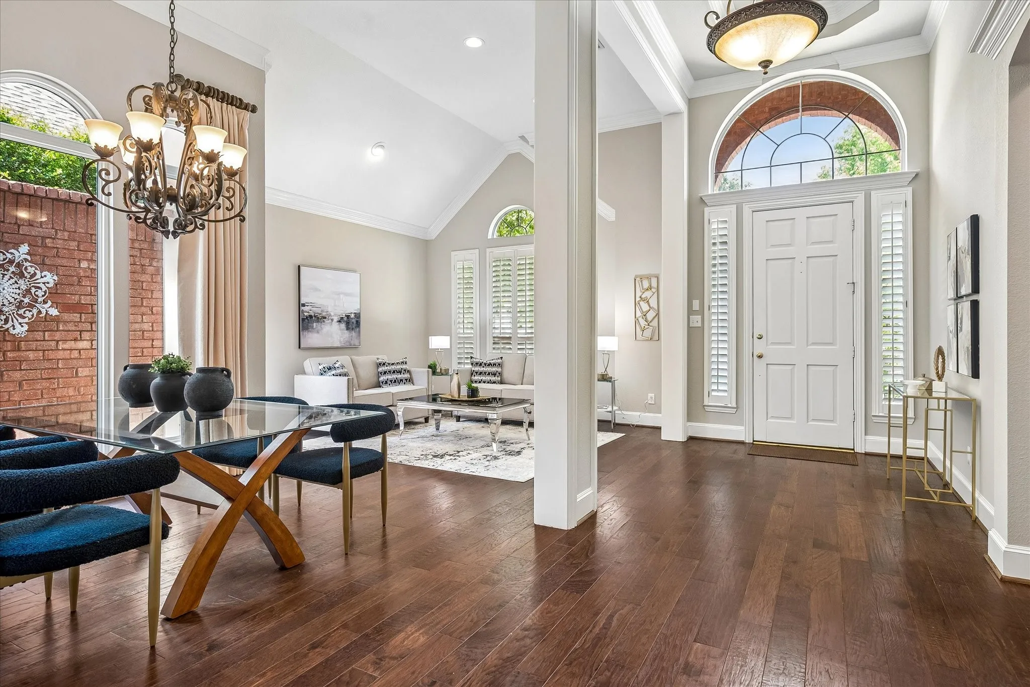 Entry with Tray ceiling, stacked formals.   Crown moldings, Wood flooring, Plantation Shutters continue throughout home.