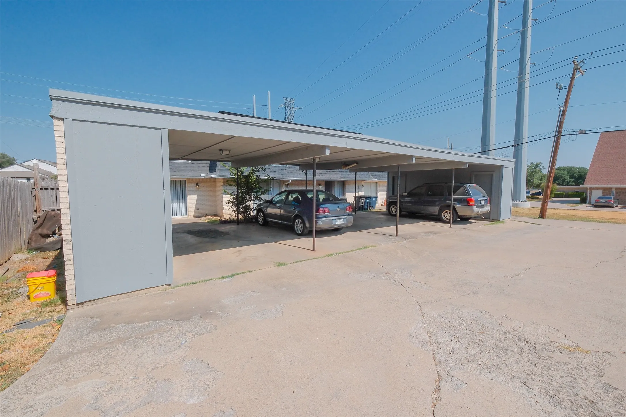 Multi-car carport structure with a light gray finish