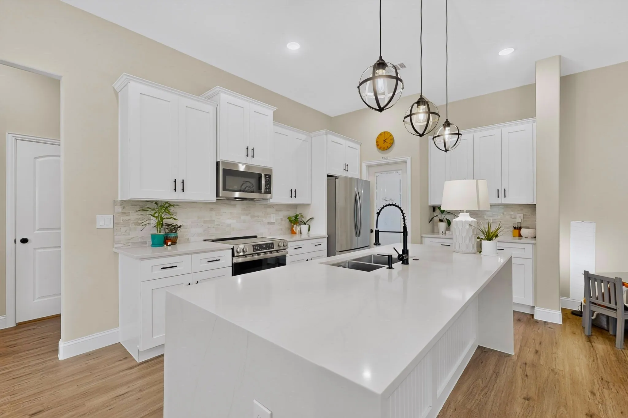 Full waterfall Quartz island seats 4 as the heart of the home.