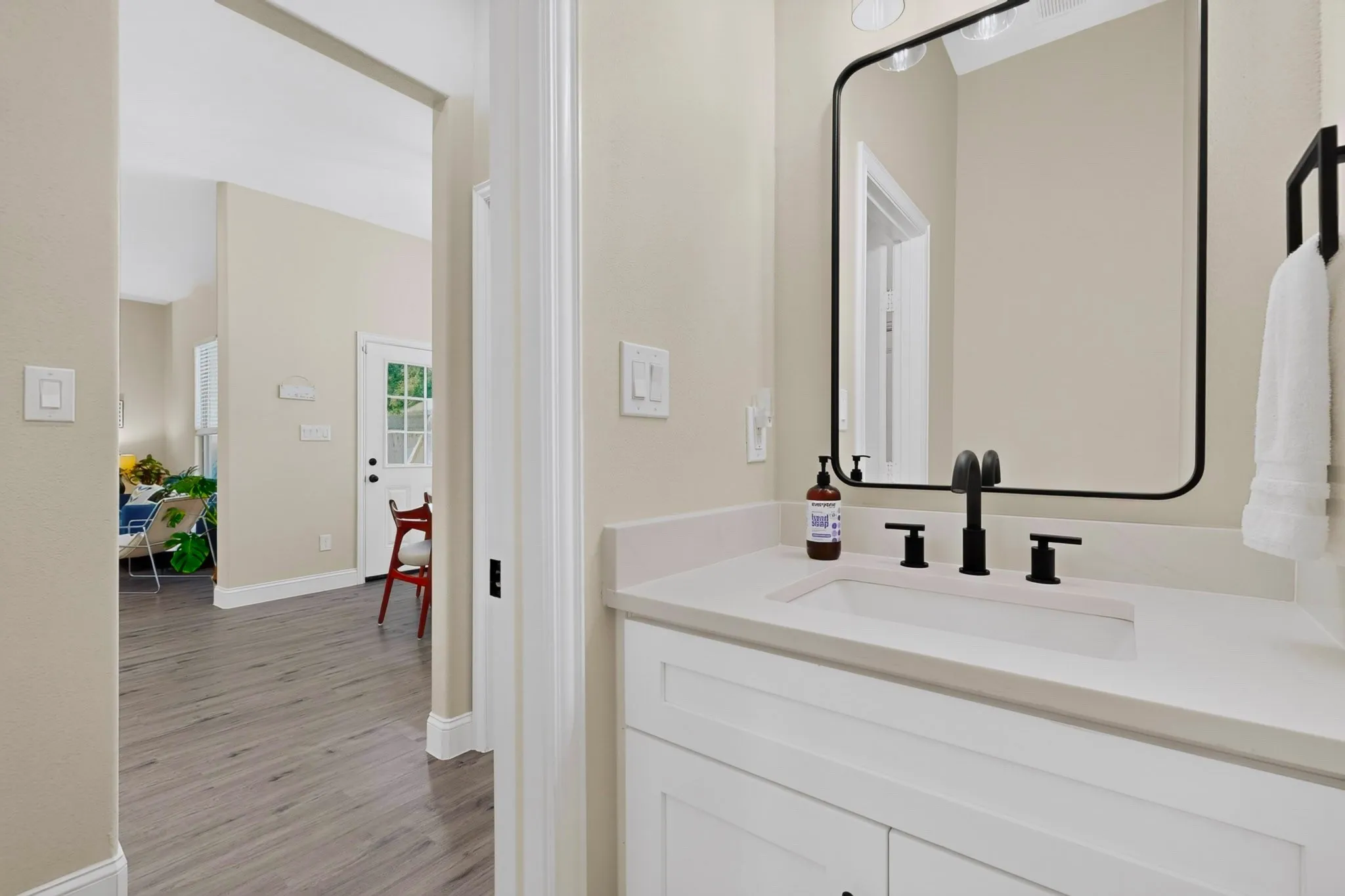 Half Bath behind the kitchen, keeps the bedrooms private.