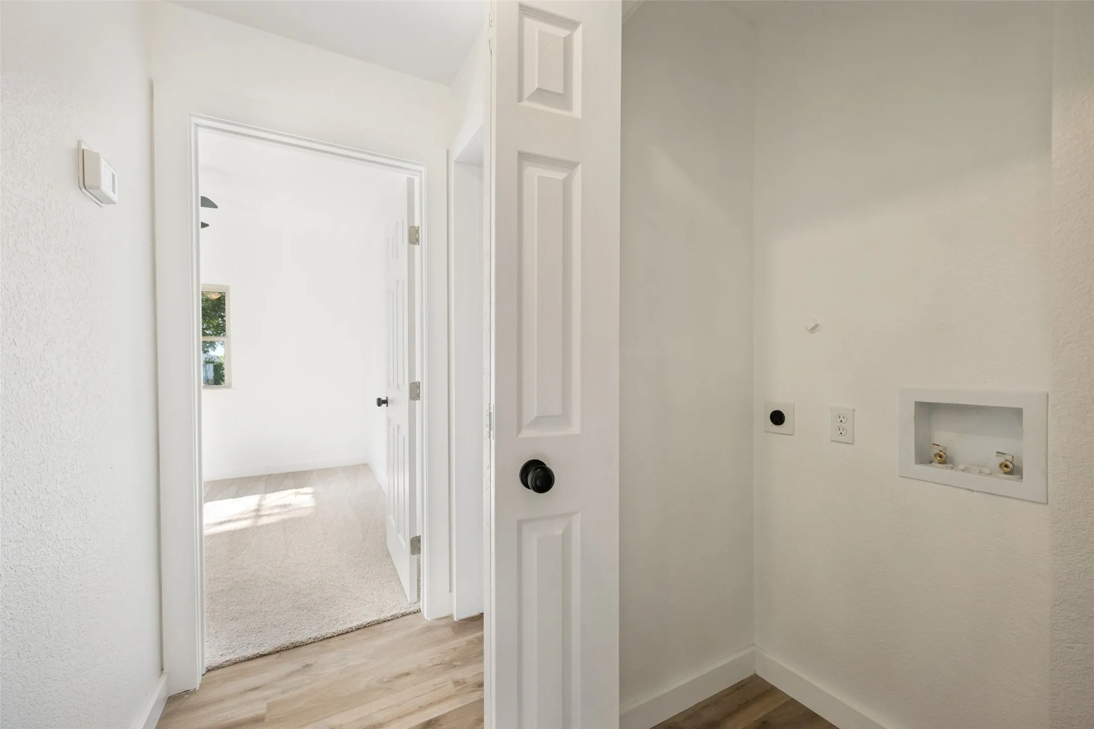 Dedicated utility area with water hookups and electrical outlet