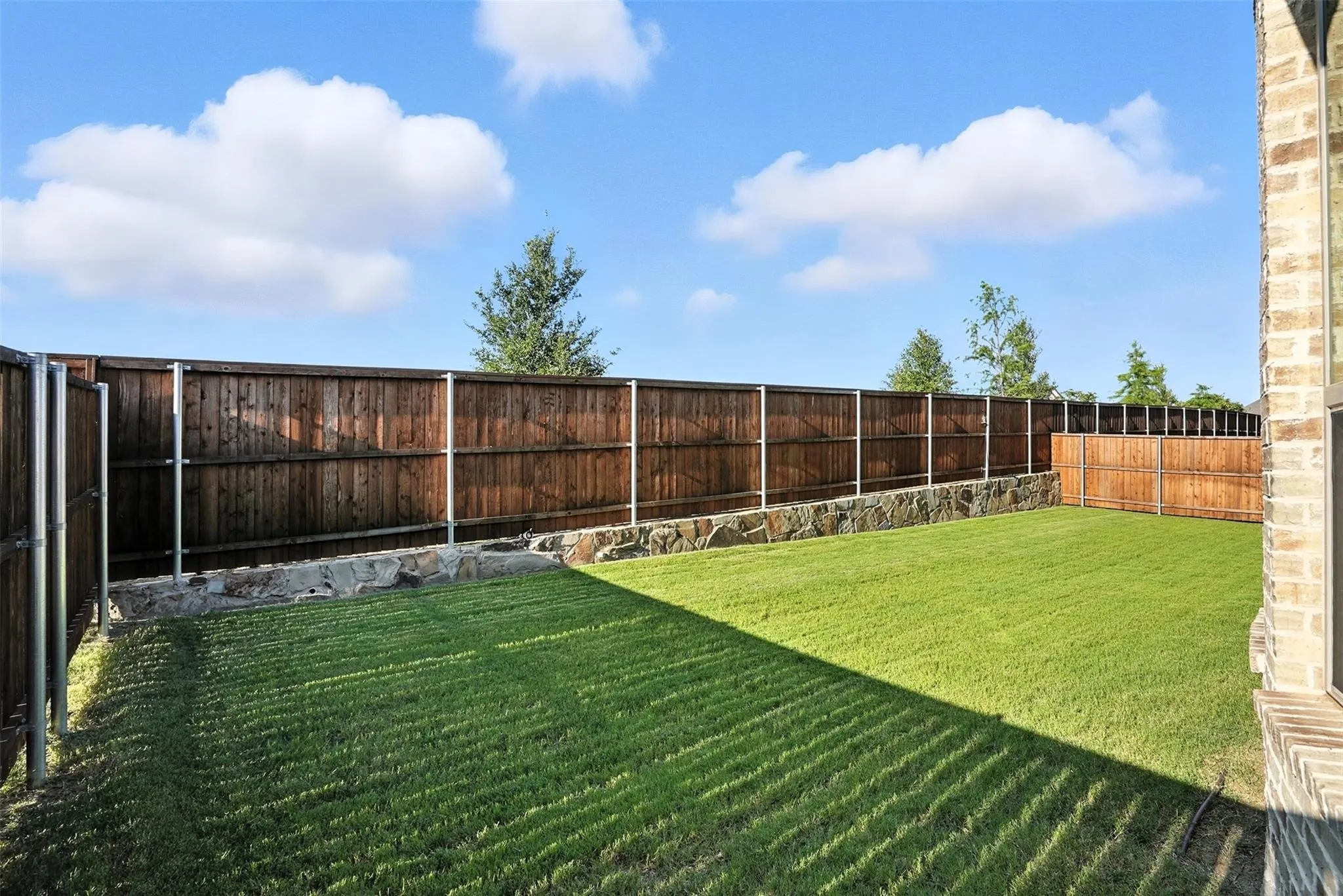 View of fenced backyard