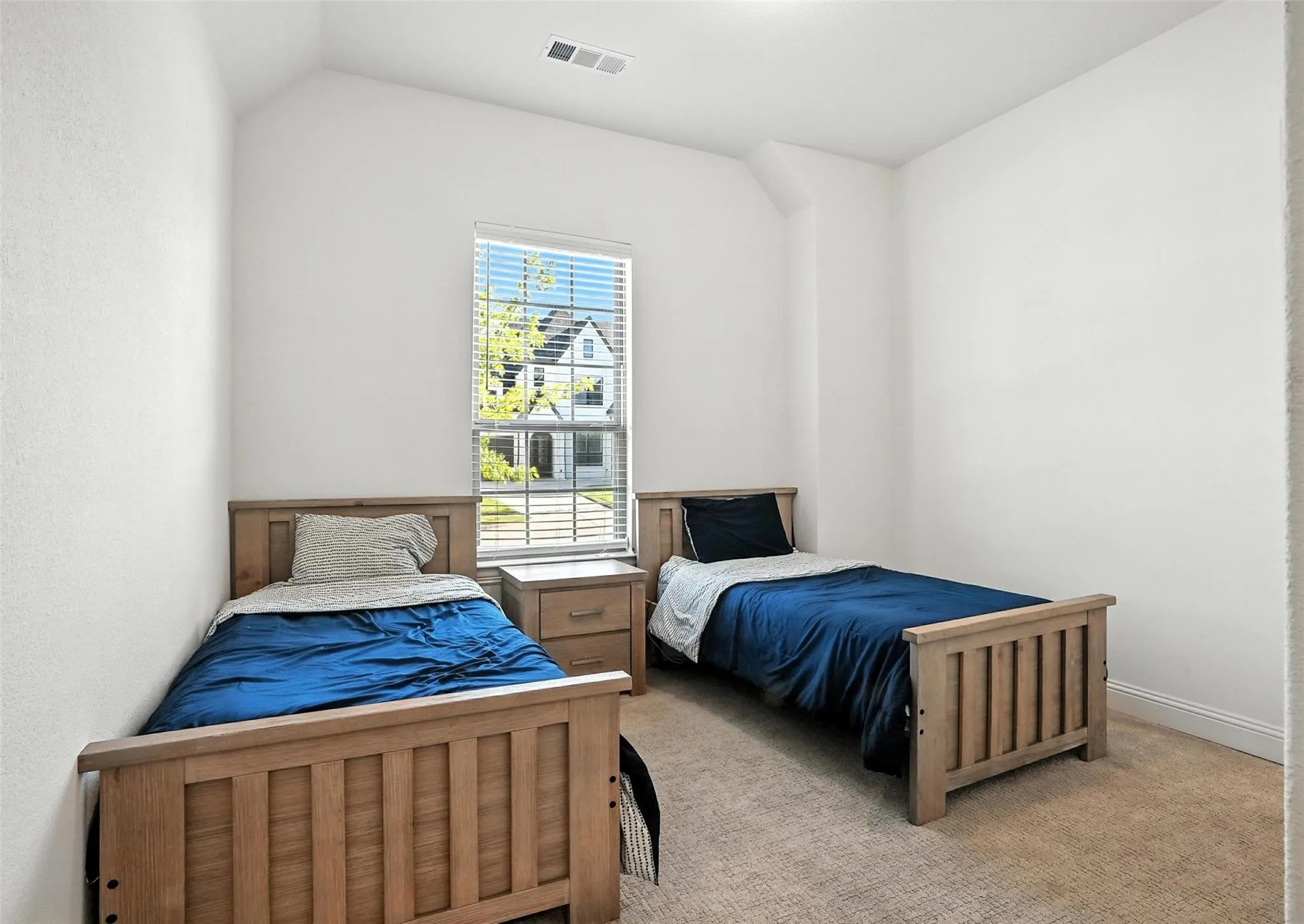 Bedroom featuring light carpet and baseboards