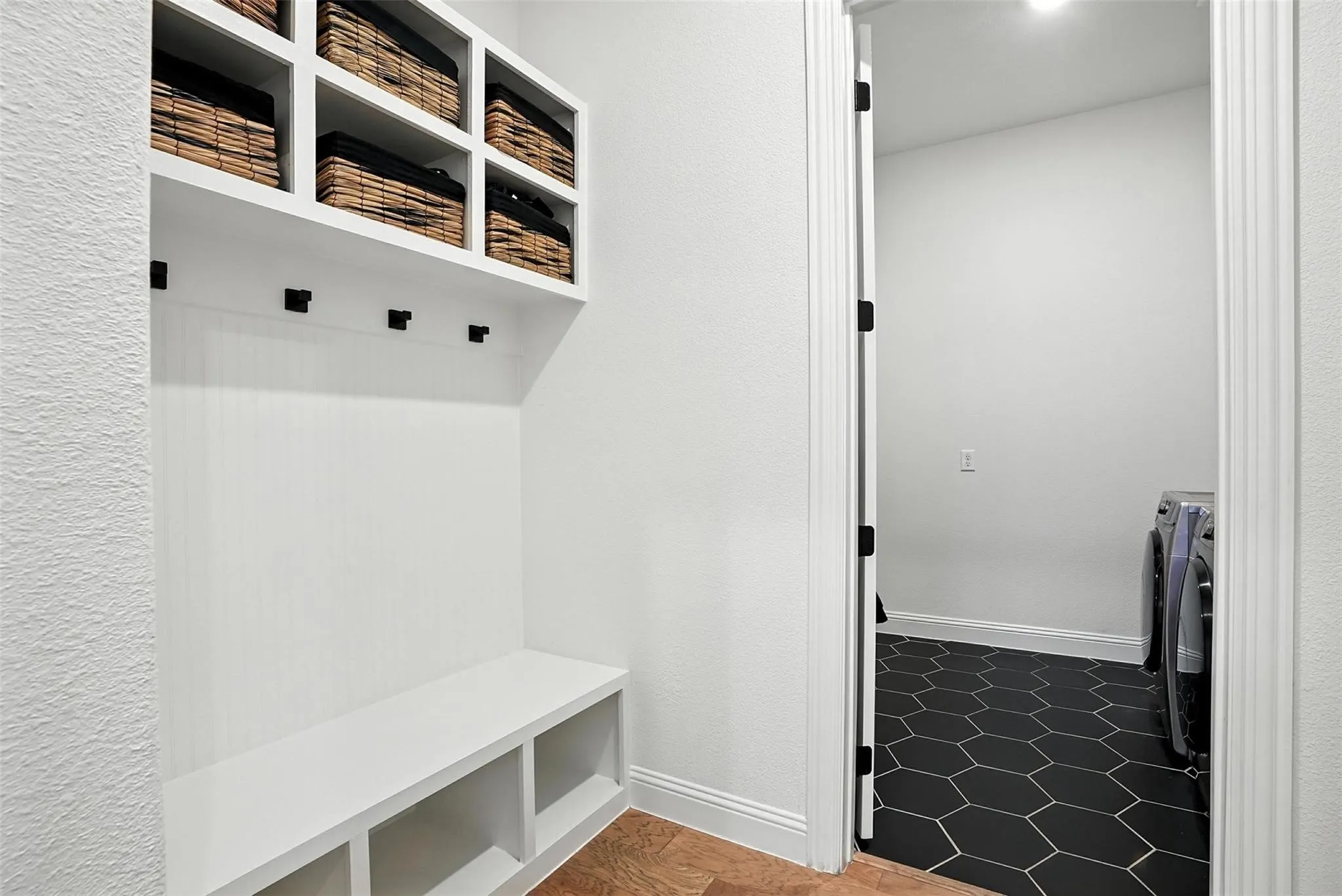 Mudroom featuring washer and dryer and baseboards