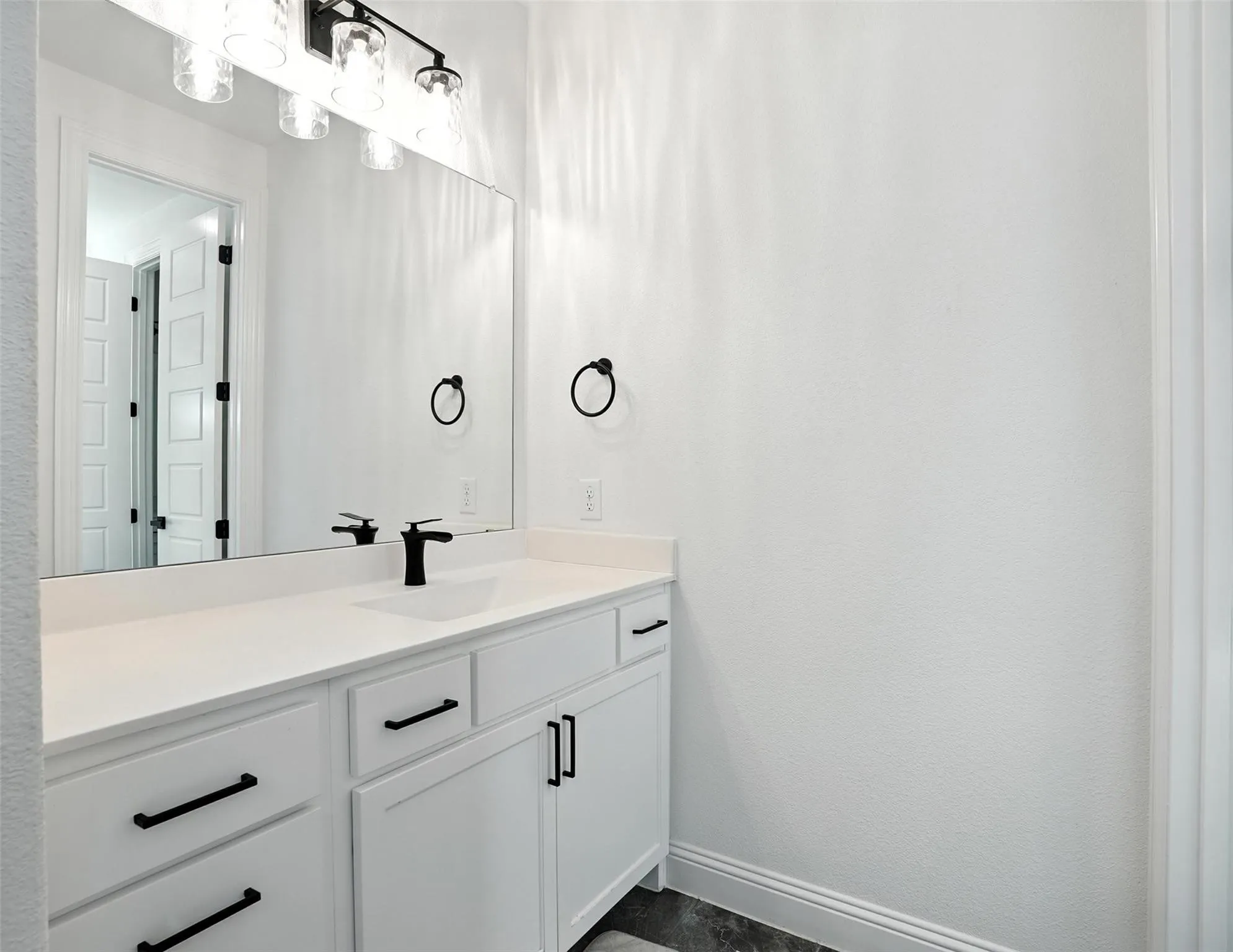 Bathroom featuring vanity and baseboards