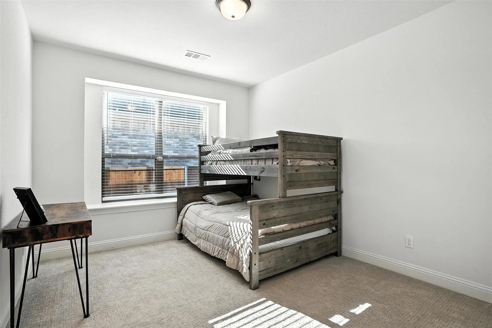 Carpeted bedroom with baseboards