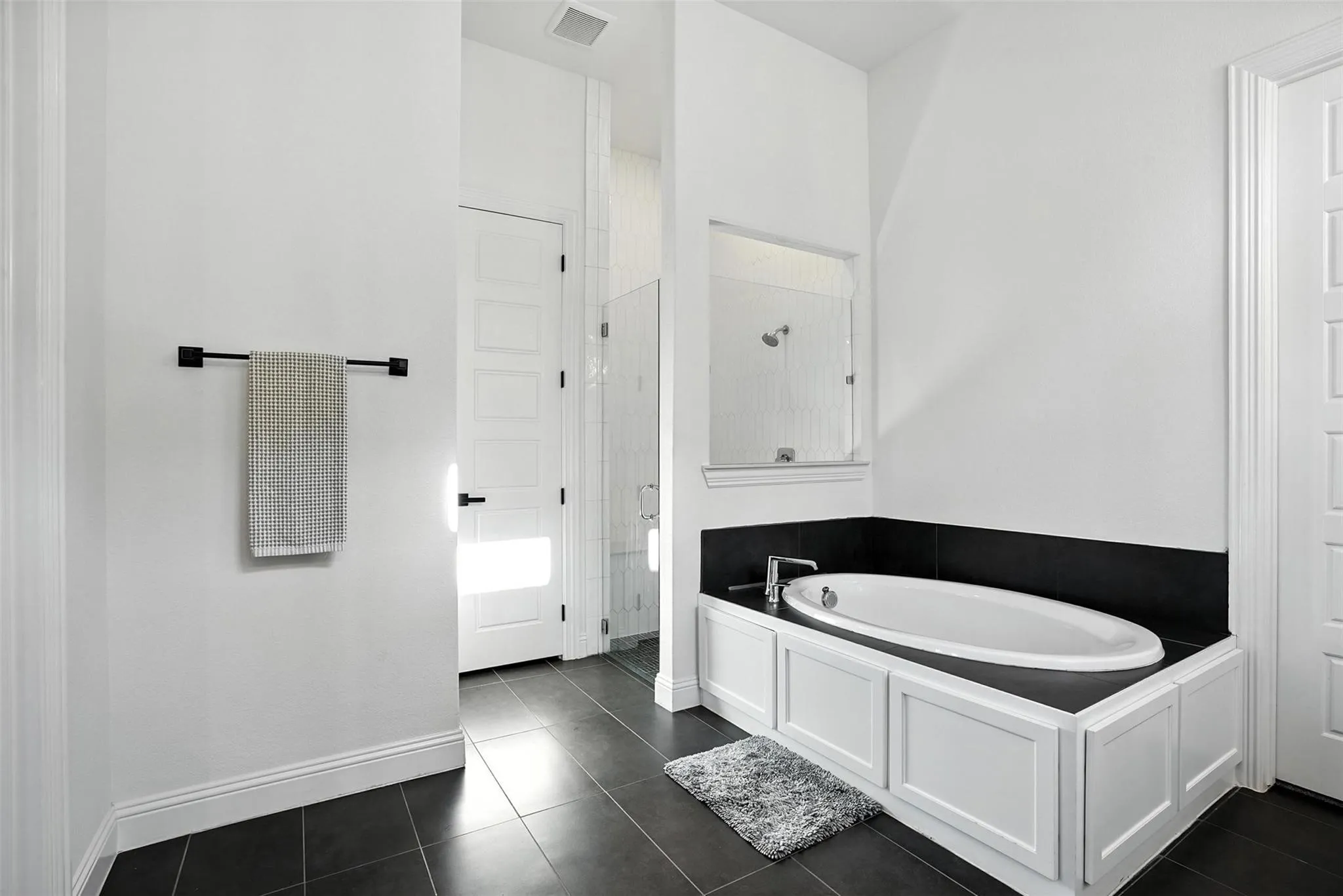 Bathroom with a shower stall, a garden tub, and tile patterned floors