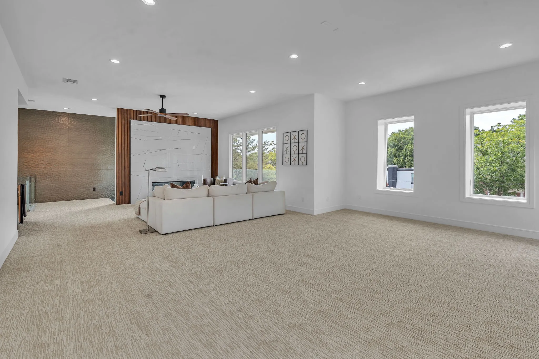 Spacious entertainment area with soundproof wall perfect for a golf simulator and pool table