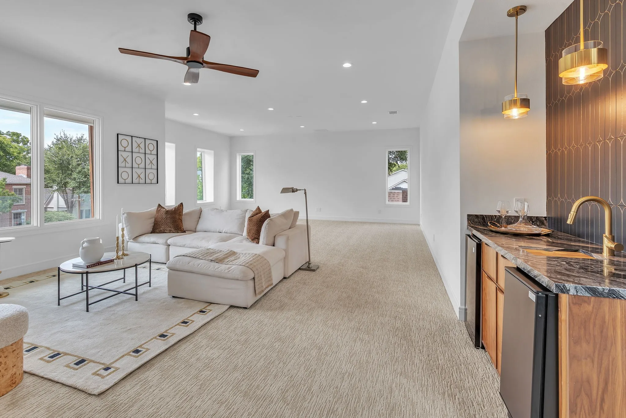 Spacious entertainment area with wet bar & soundproof wall perfect for a golf simulator and pool table