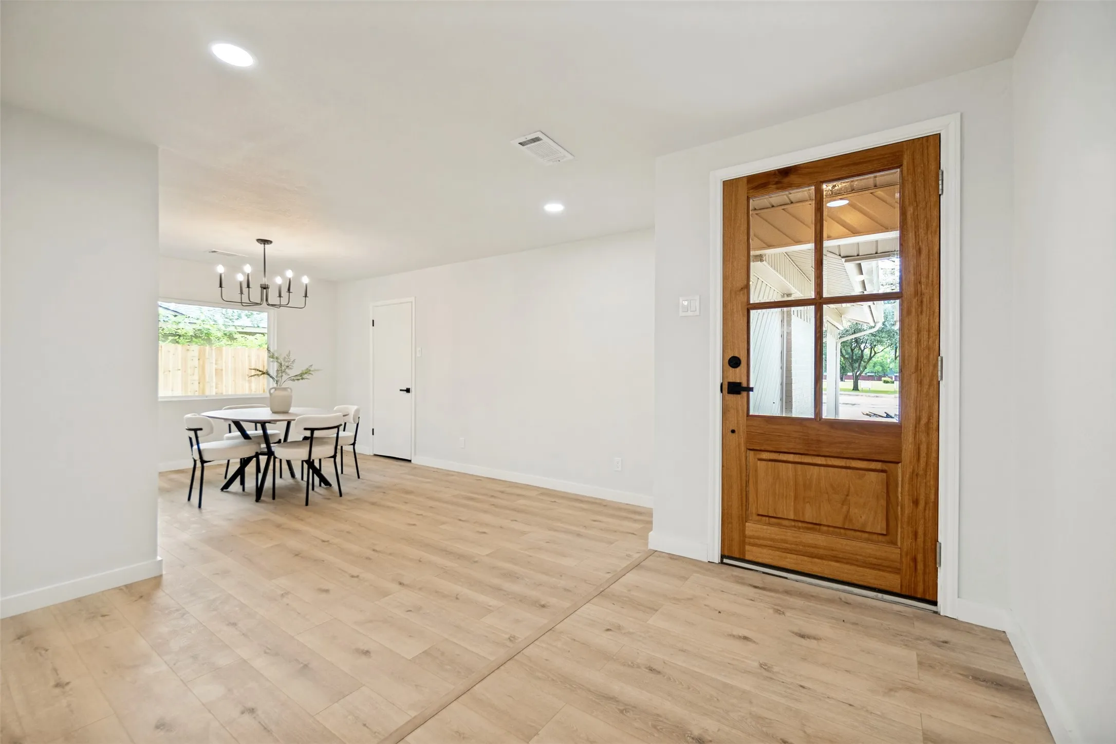 Entryway featuring a natural wood-finish door with multi-pane glass