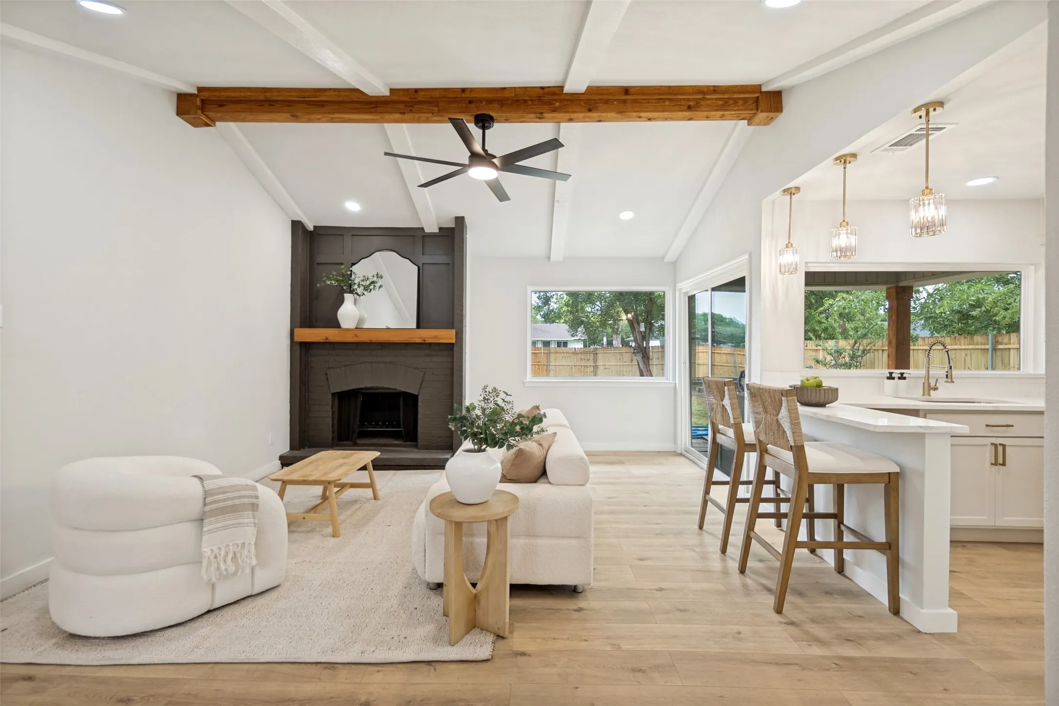 Vaulted ceiling with exposed wood beams and ceiling fan