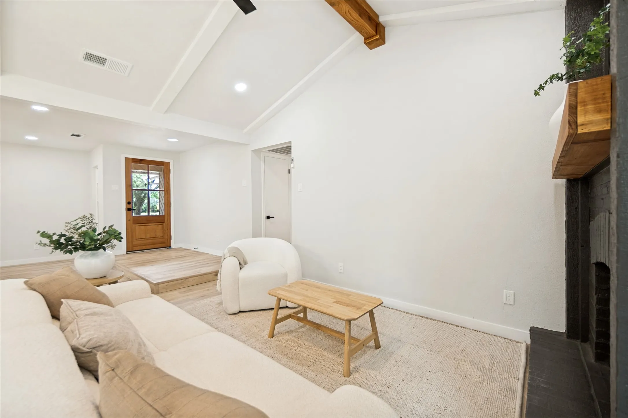 Vaulted white ceiling with exposed wood beams