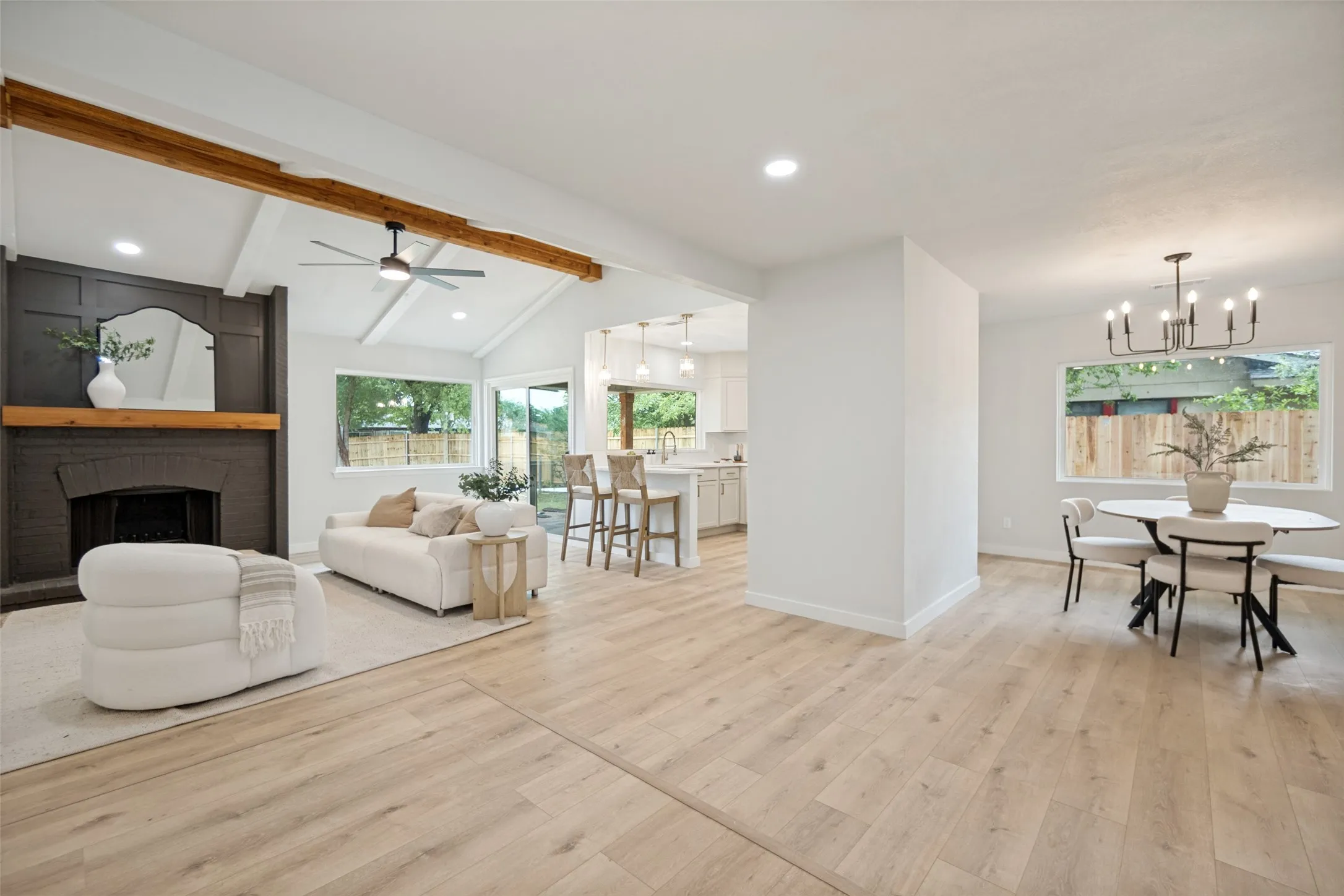 Vaulted ceilings with exposed wood beams highlight this expansive living area
