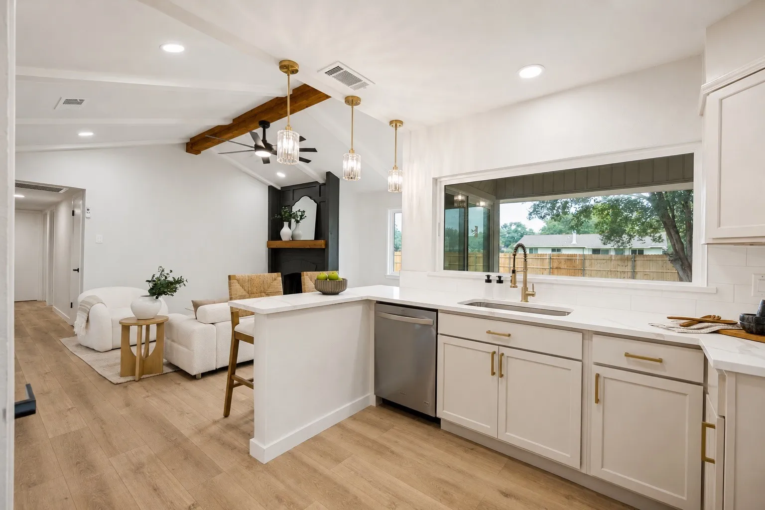 Open-concept kitchen and living area featuring a vaulted ceiling with exposed wood beam, recessed lighting, and wood-finish flooring