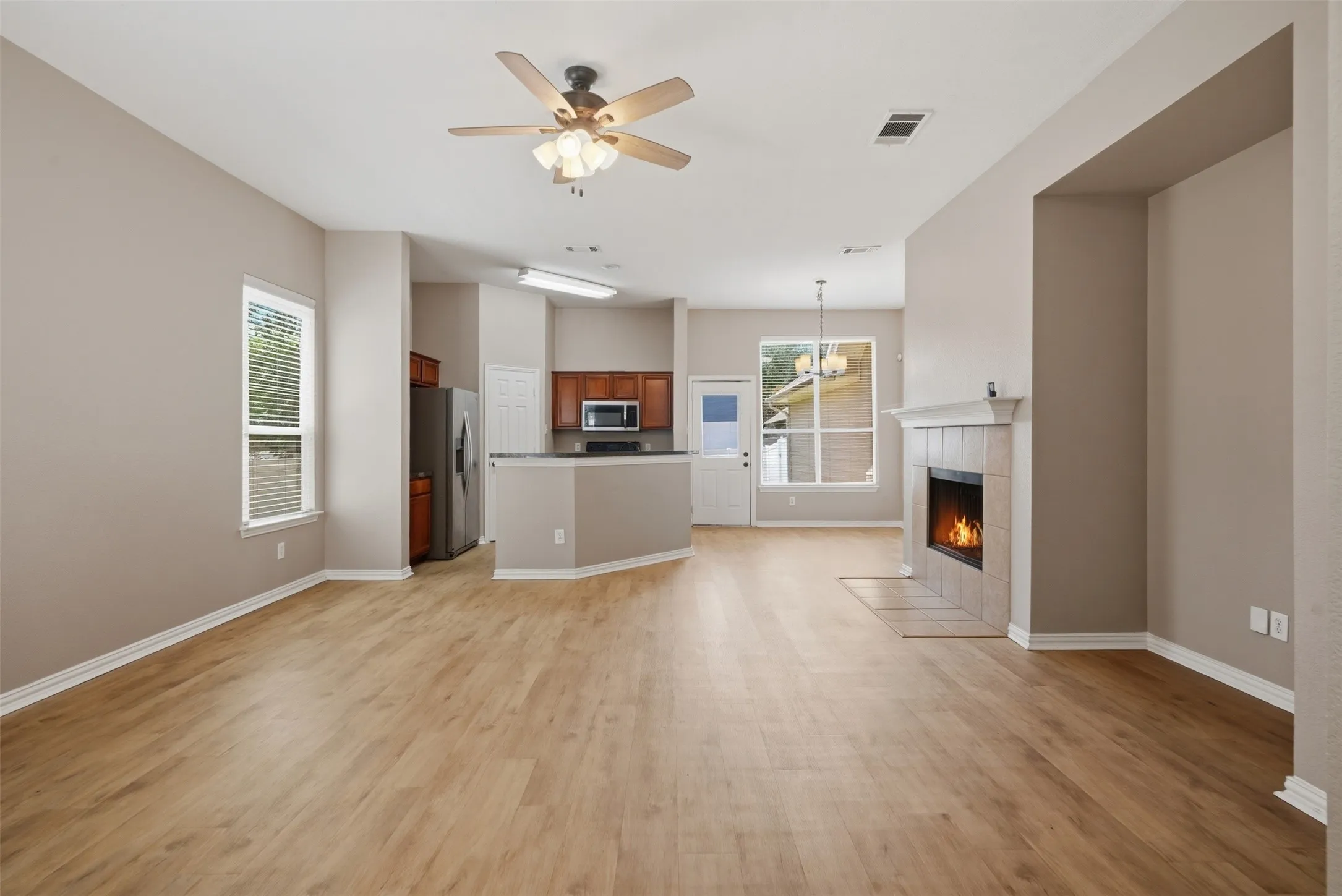 Bright and spacious open floor plan seamlessly connects the living room, kitchen, and dining area; perfect for everyday living and entertaining.