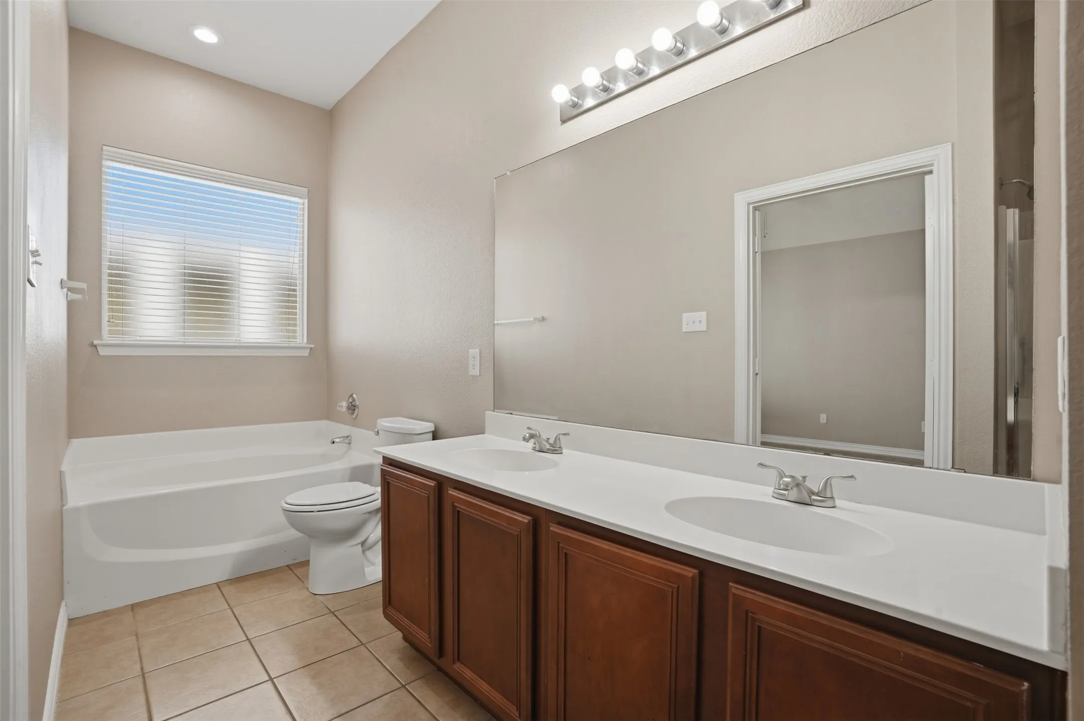 Spacious dual-sink vanity provides ample counter space and added convenience for busy mornings.