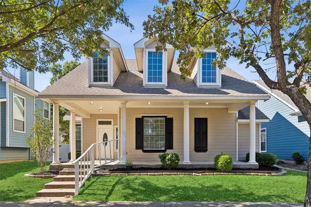 Welcoming covered front porch with classic columns provides the perfect space to relax and enjoy the neighborhood.