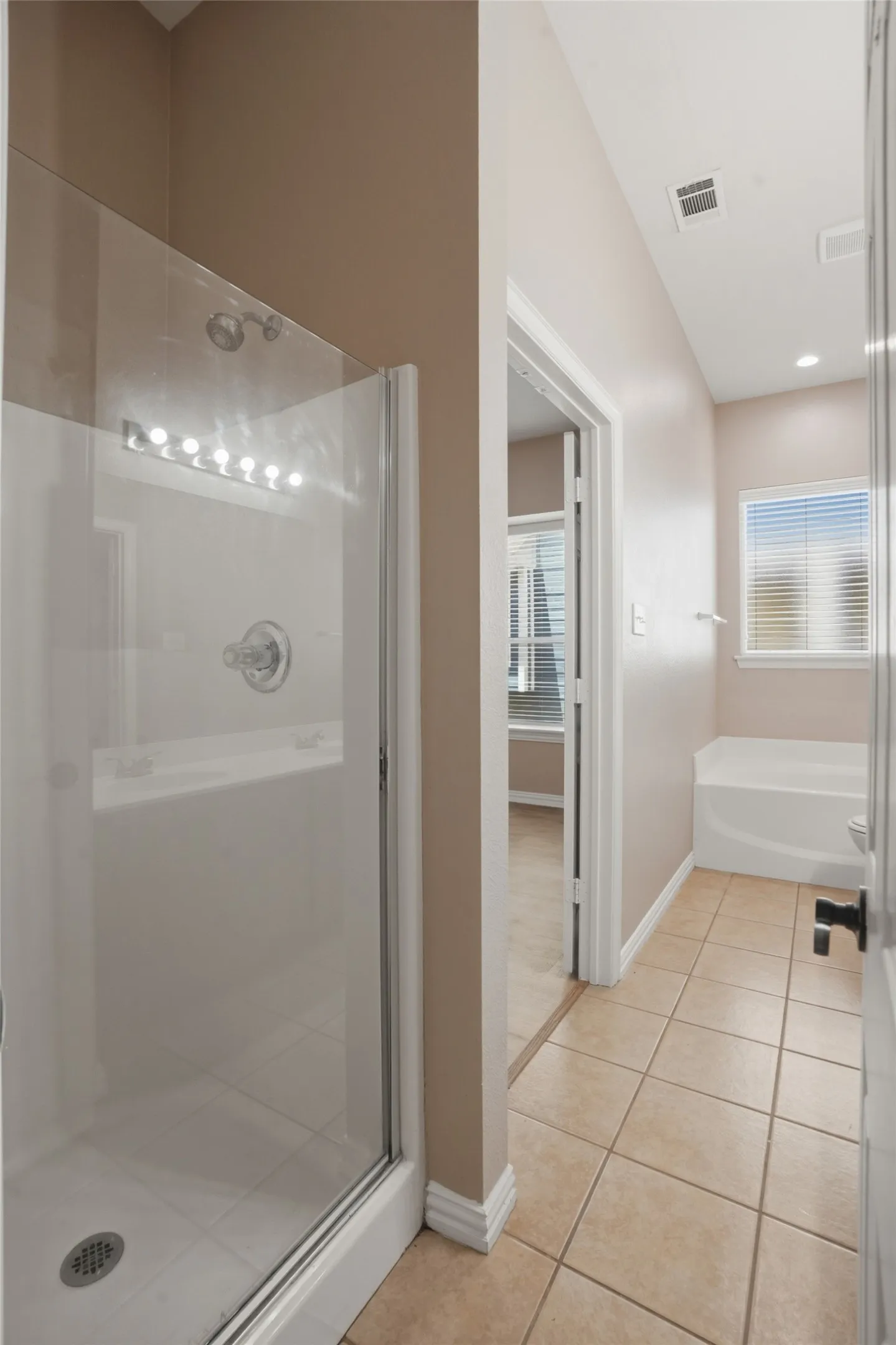 Relaxing garden tub and separate walk-in shower offer the perfect combination of comfort and functionality.