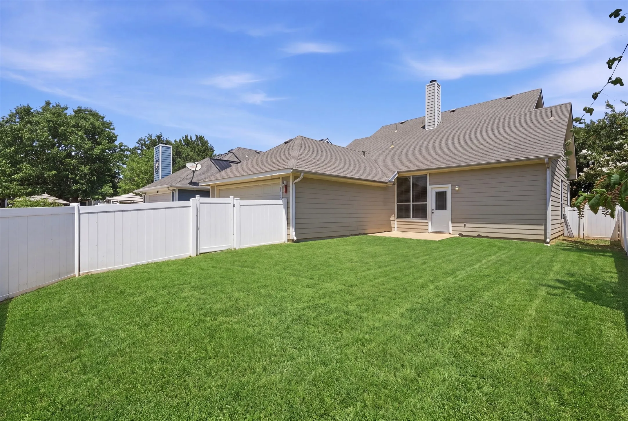 Generous backyard layout is perfect for hosting gatherings, family barbecues, or enjoying quiet evenings outdoors.