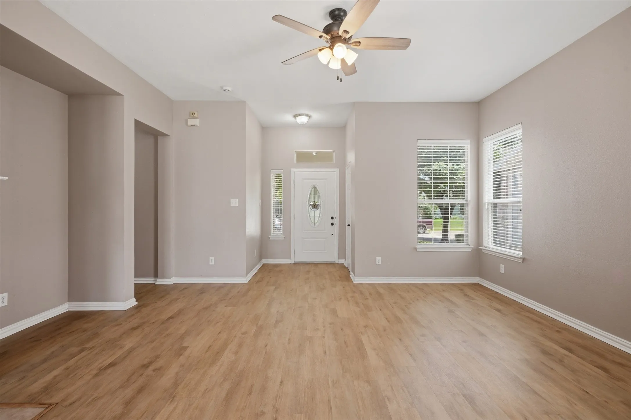 Durable luxury vinyl plank flooring extends throughout the main living spaces, offering both style and easy maintenance.