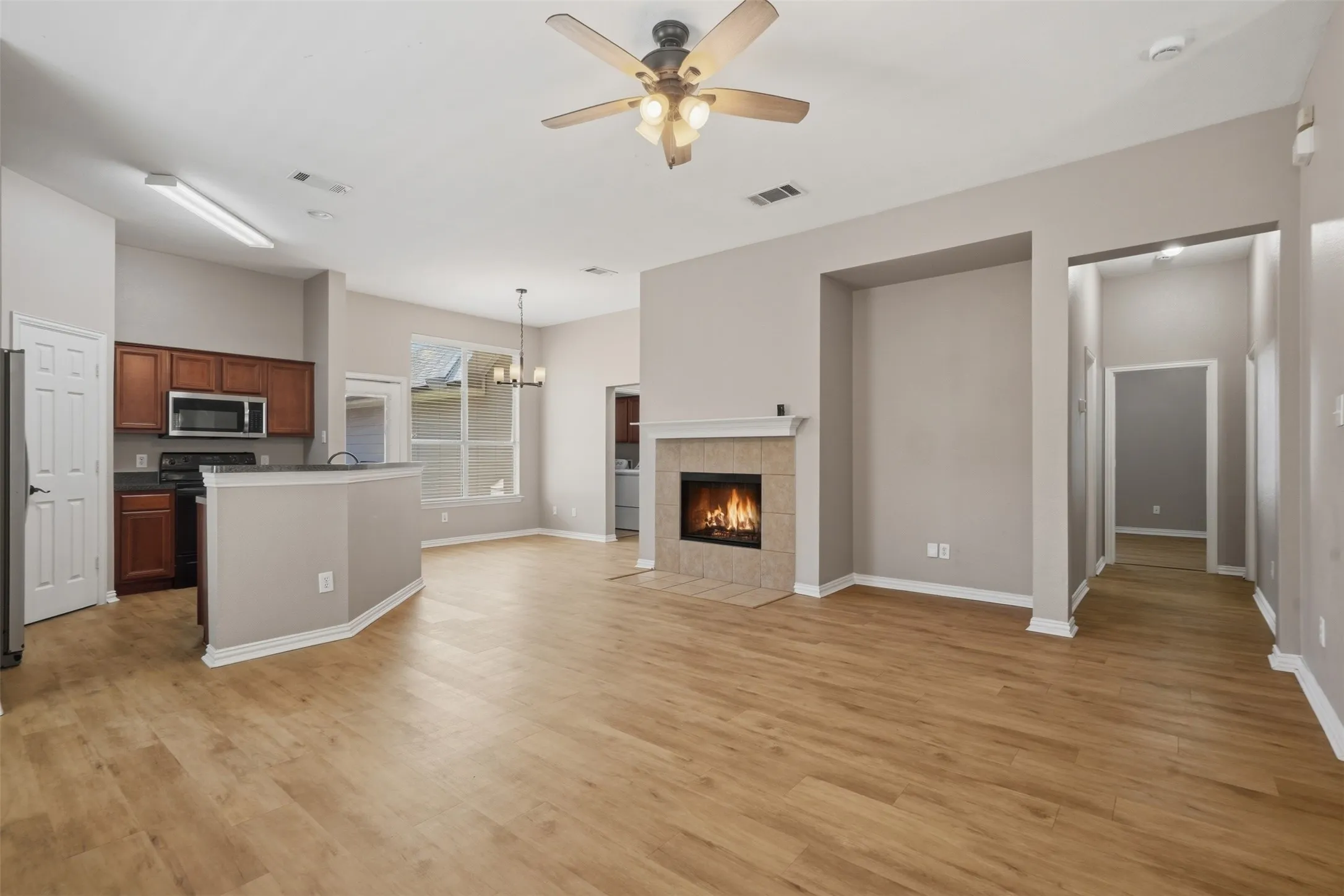 Inviting corner fireplace with tile surround and classic mantel creates a warm focal point for the main living area.