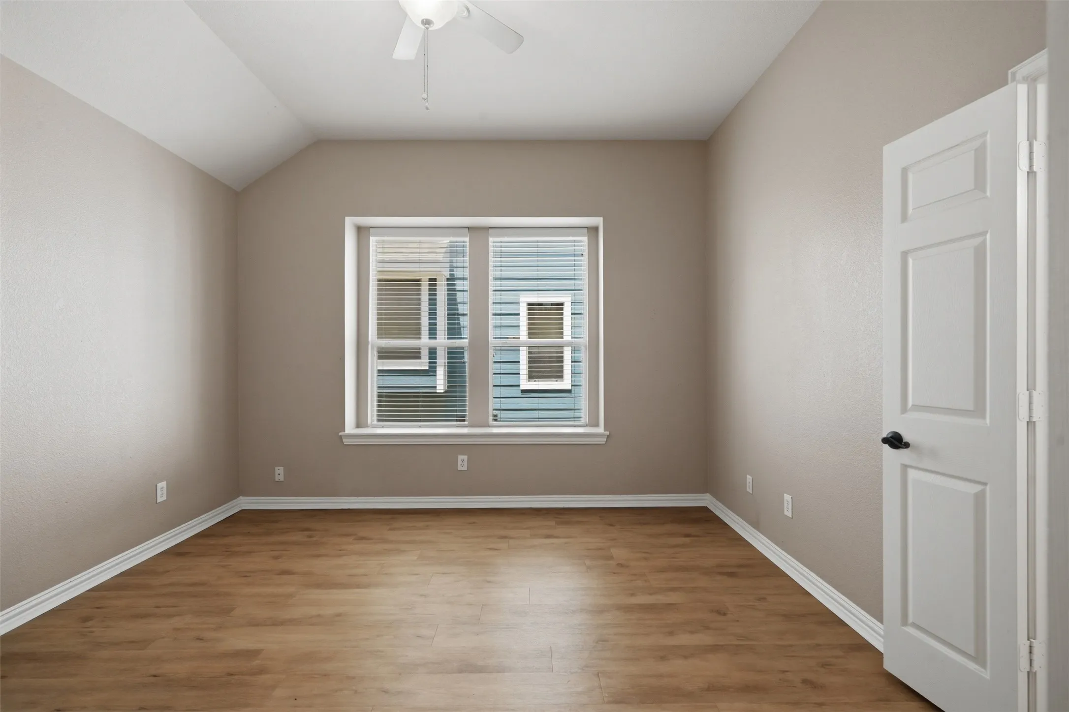 Oversized windows fill the room with abundant natural light, creating a bright and inviting retreat.