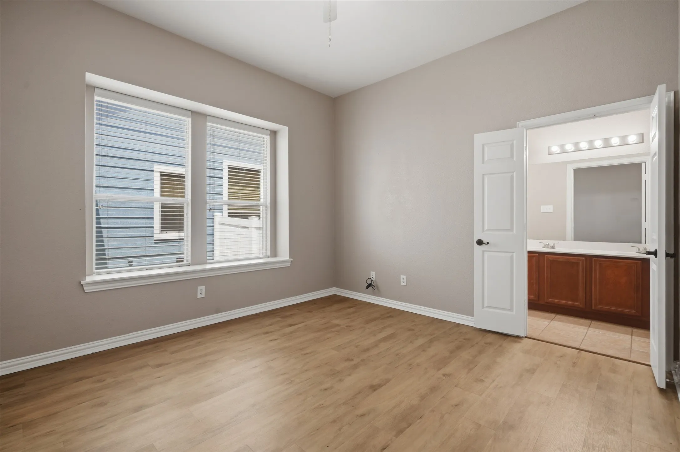 Primary suite includes a private en-suite bath with an extended dual-sink vanity for added convenience.