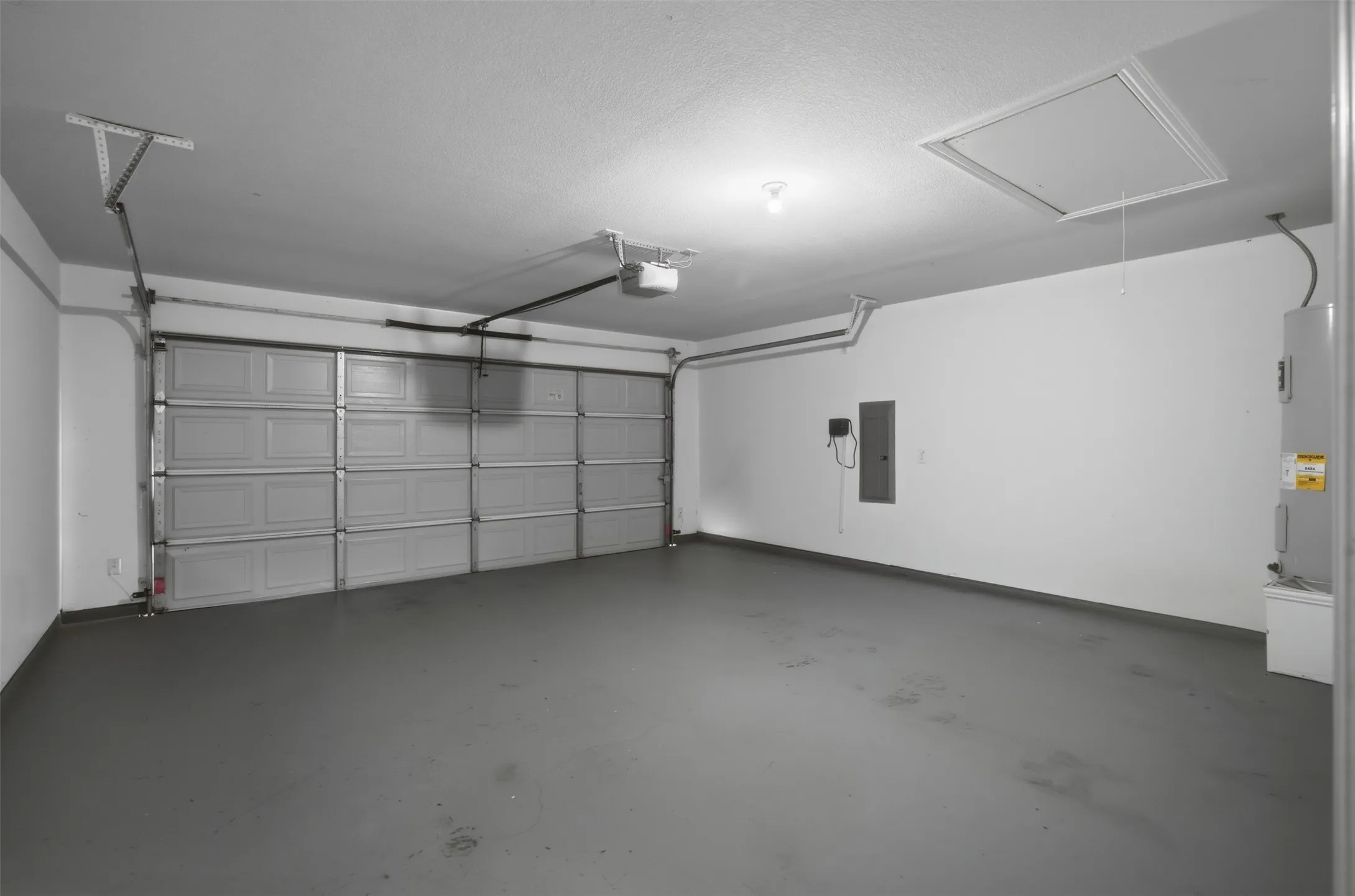 Clean, finished garage with painted walls and durable coated flooring for a polished, low-maintenance space.