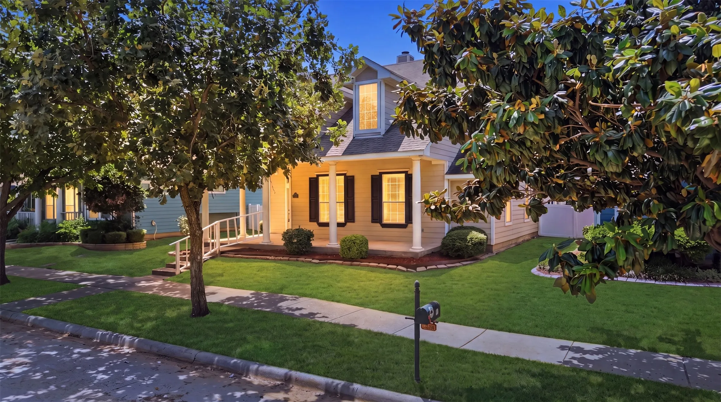 Timeless exterior design with decorative shutters, dormer window, and clean architectural lines that create a warm first impression.