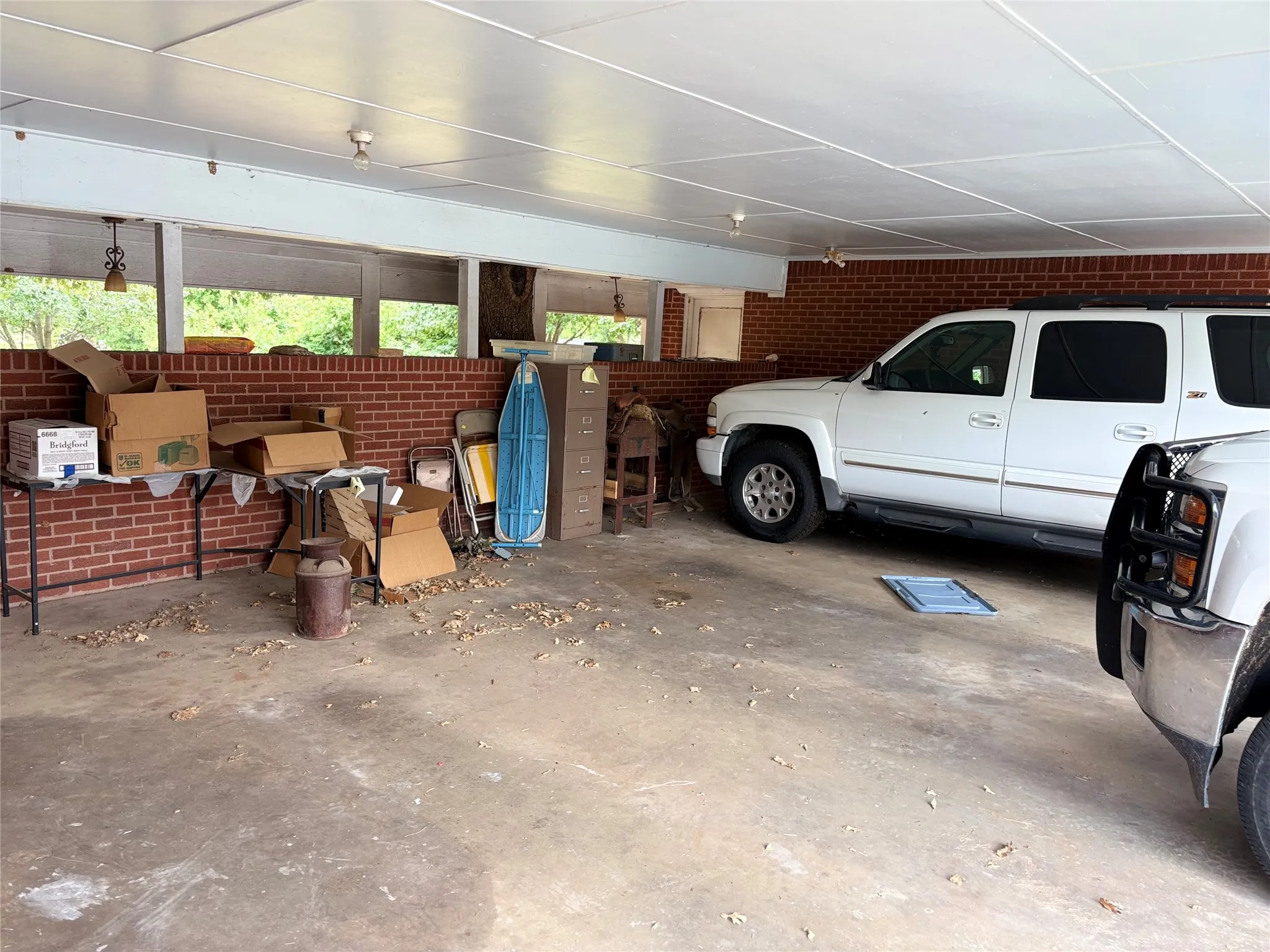 Carport with concrete flooring and a paneled ceiling