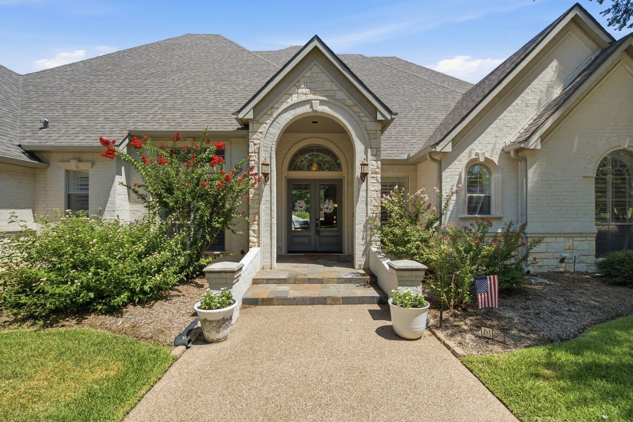 Architectural stone and brick facade with a grand arched entry